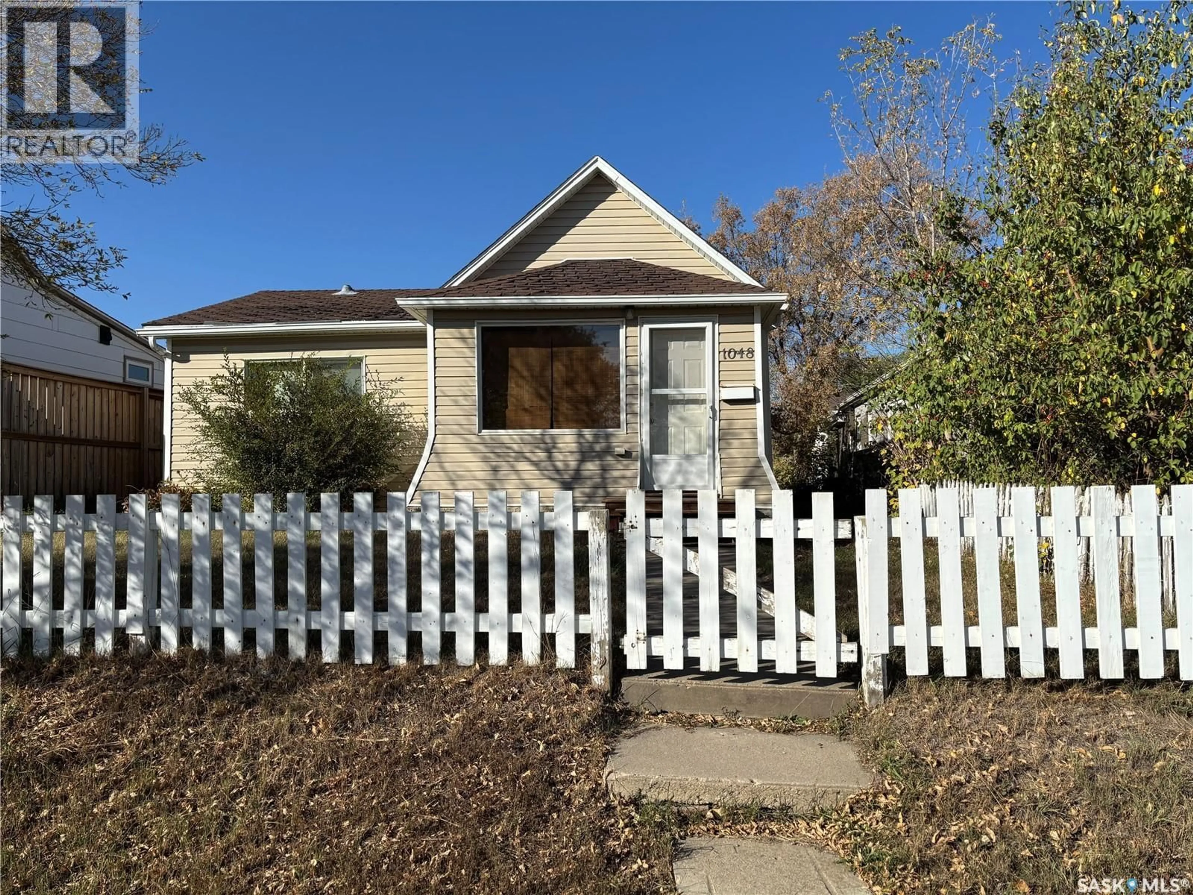 Home with vinyl exterior material, street for 1048 OMINICA STREET, Moose Jaw Saskatchewan S6H0J3