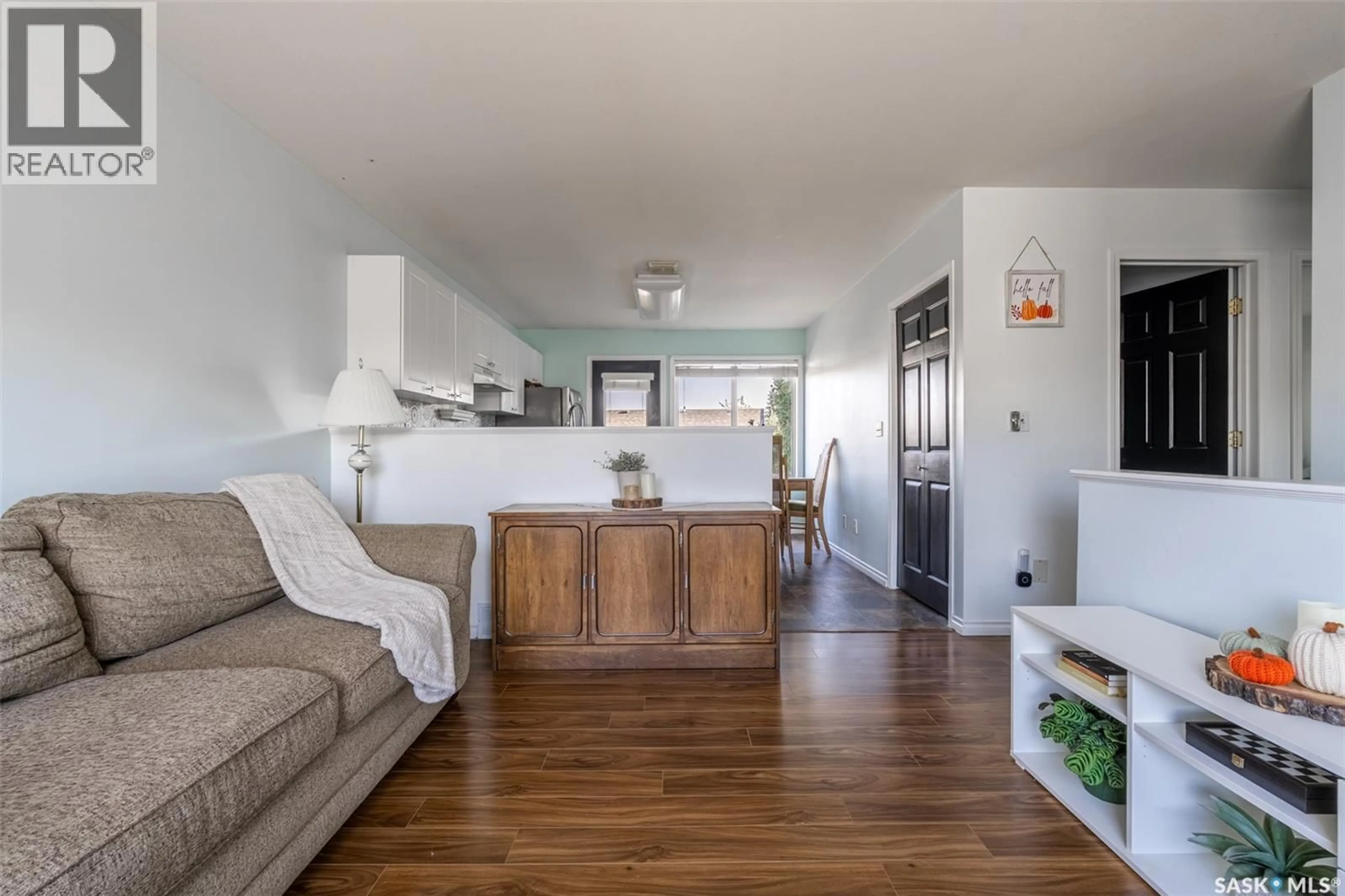 Living room with furniture, wood/laminate floor for 13 143 GROPPER CRESCENT, Saskatoon Saskatchewan S7M5W2