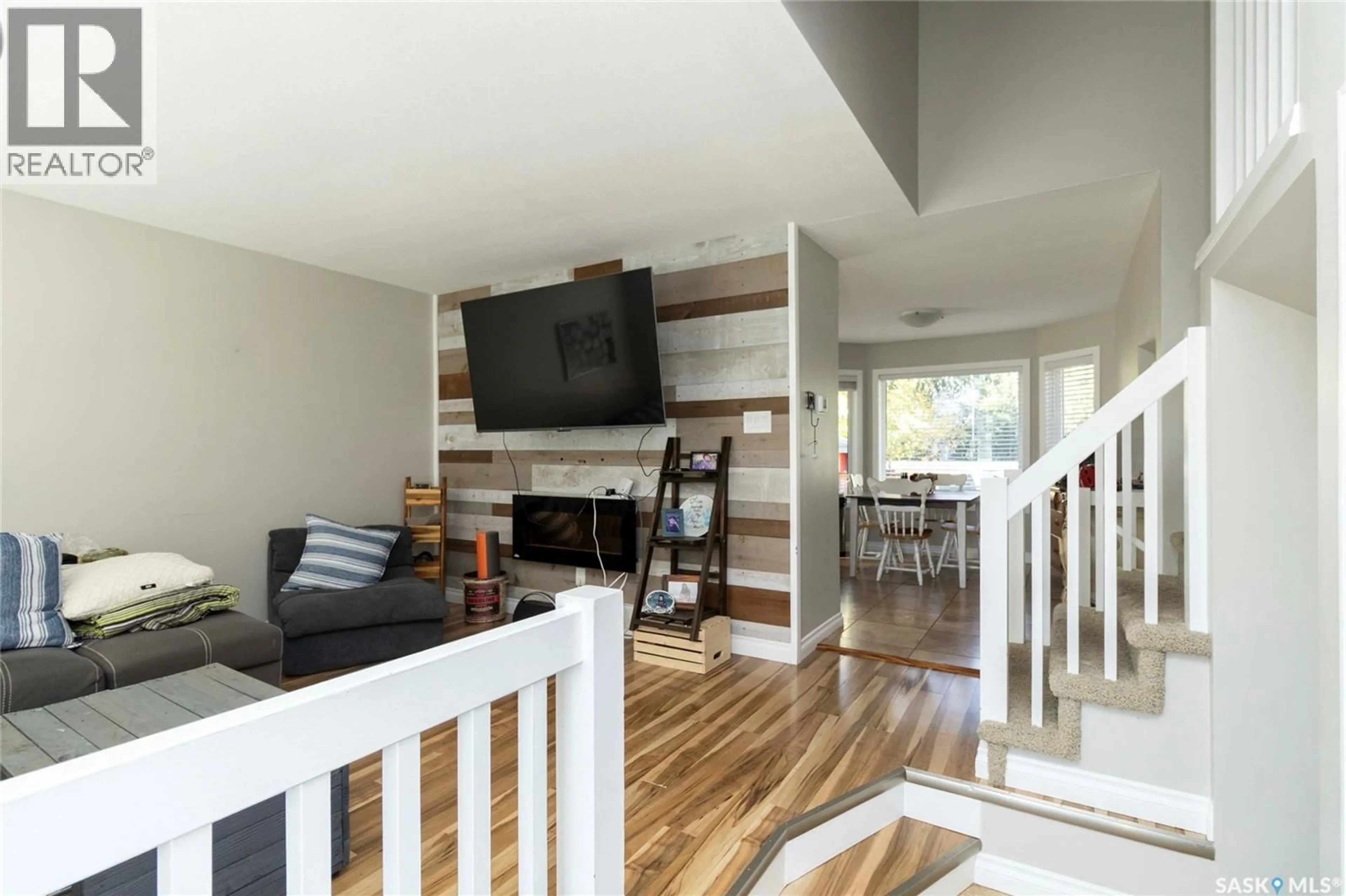 Living room with furniture, wood/laminate floor for 418 KENDERDINE ROAD, Saskatoon Saskatchewan S7N3S1