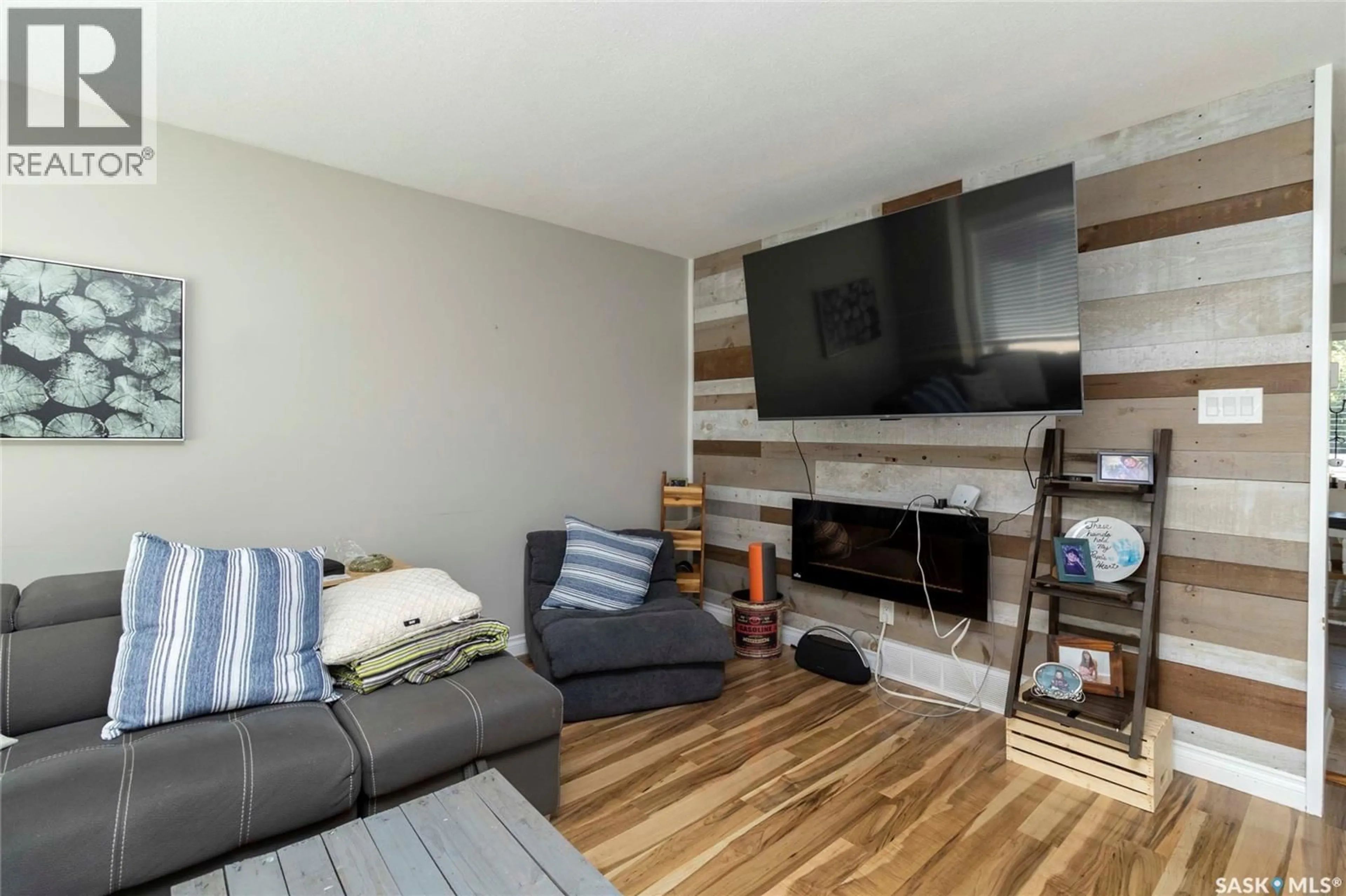 Living room with furniture, wood/laminate floor for 418 KENDERDINE ROAD, Saskatoon Saskatchewan S7N3S1