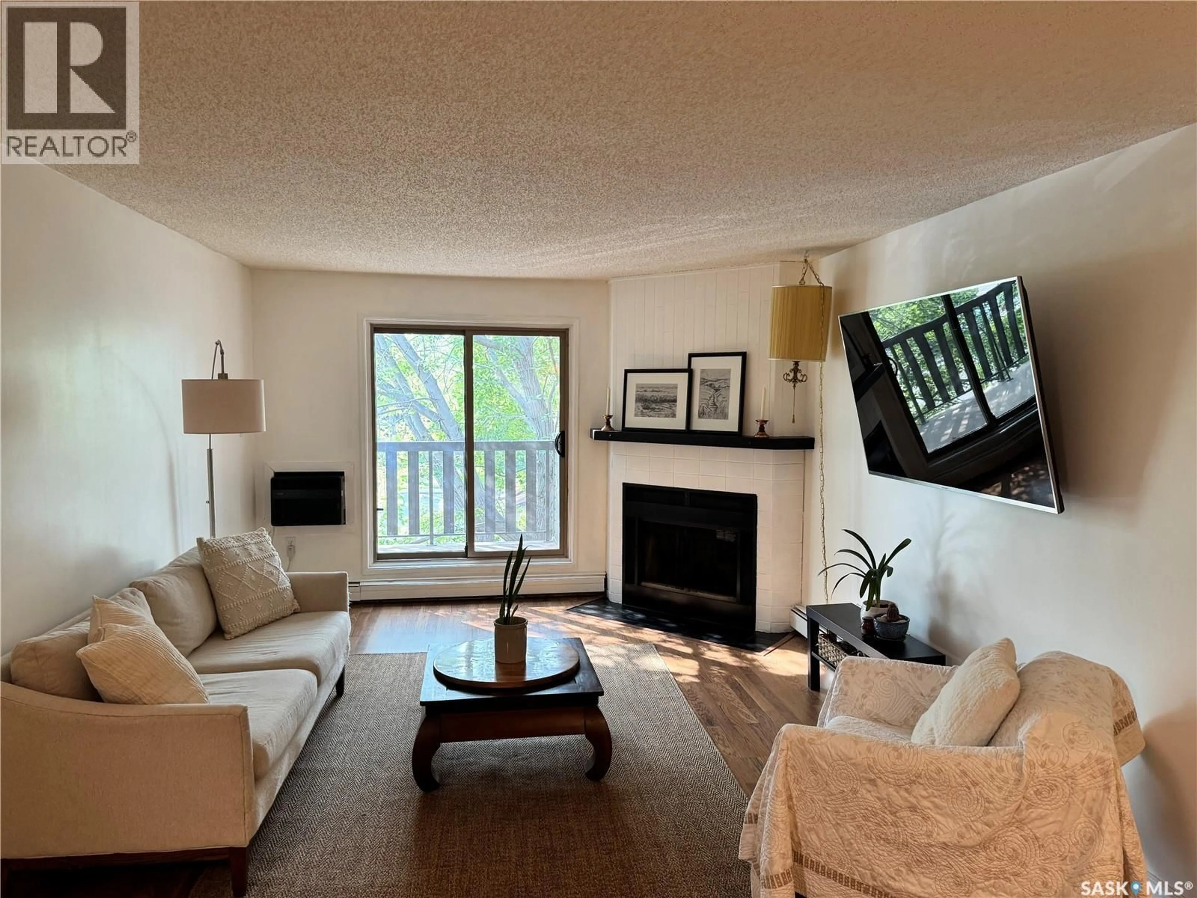 Living room with furniture, wood/laminate floor for 122 - 319 EDINBURGH PLACE, Saskatoon Saskatchewan S7H5J7