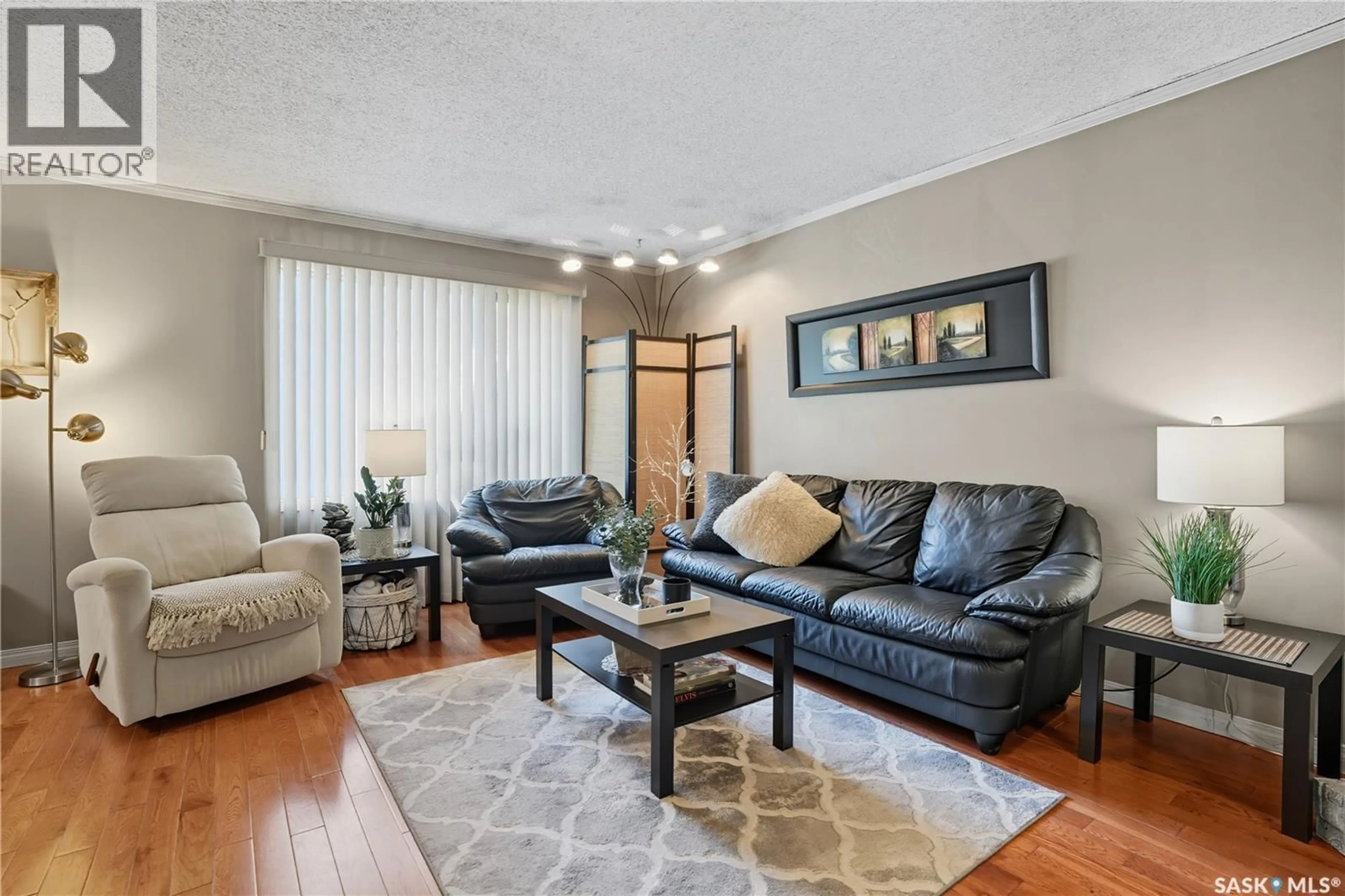 Living room with furniture, wood/laminate floor for 607 KELSEY STREET, Regina Saskatchewan S4X1V6