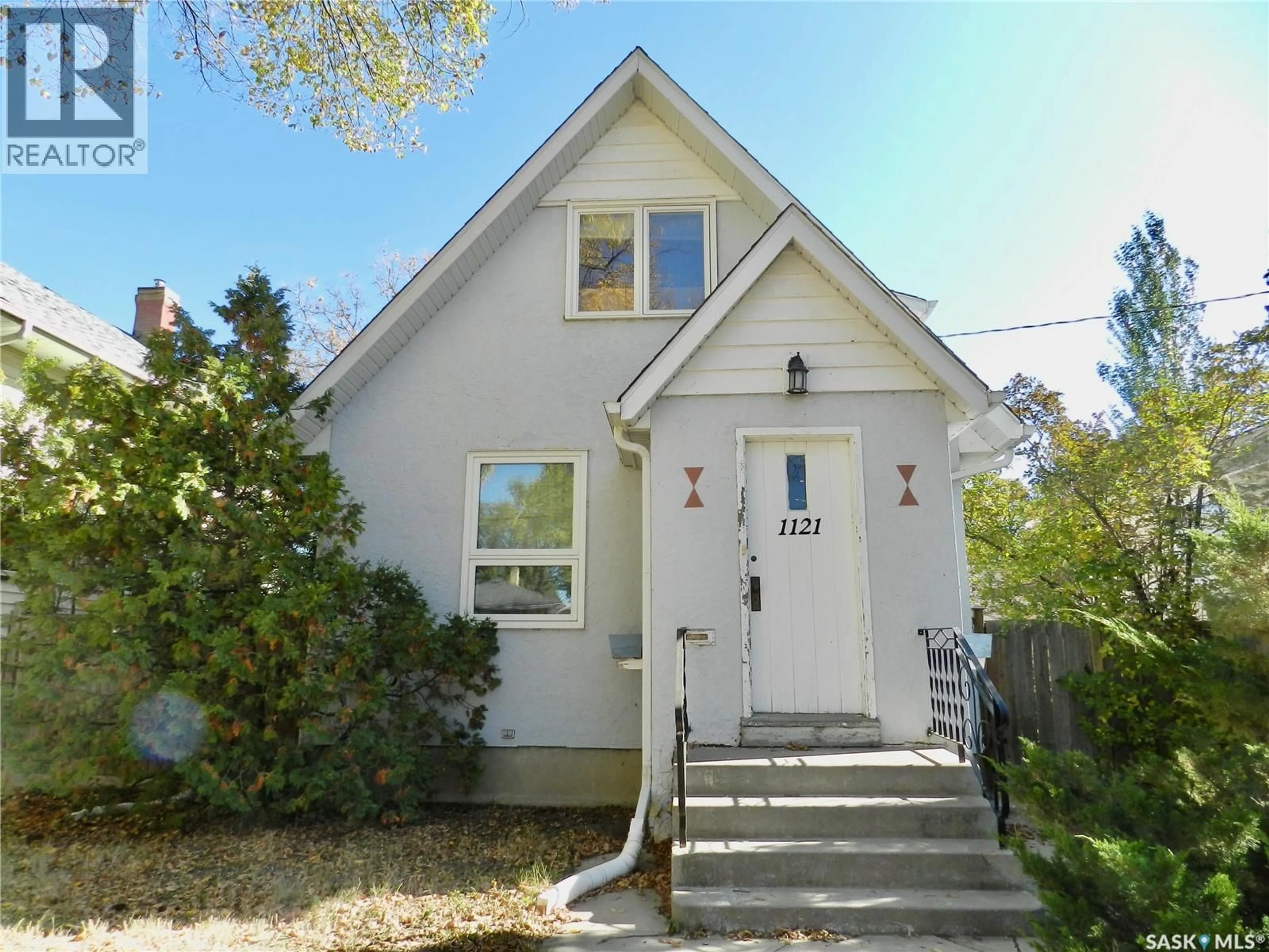 Home with vinyl exterior material, street for NW - 1121 6TH AVENUE, Moose Jaw Saskatchewan S6H4A7