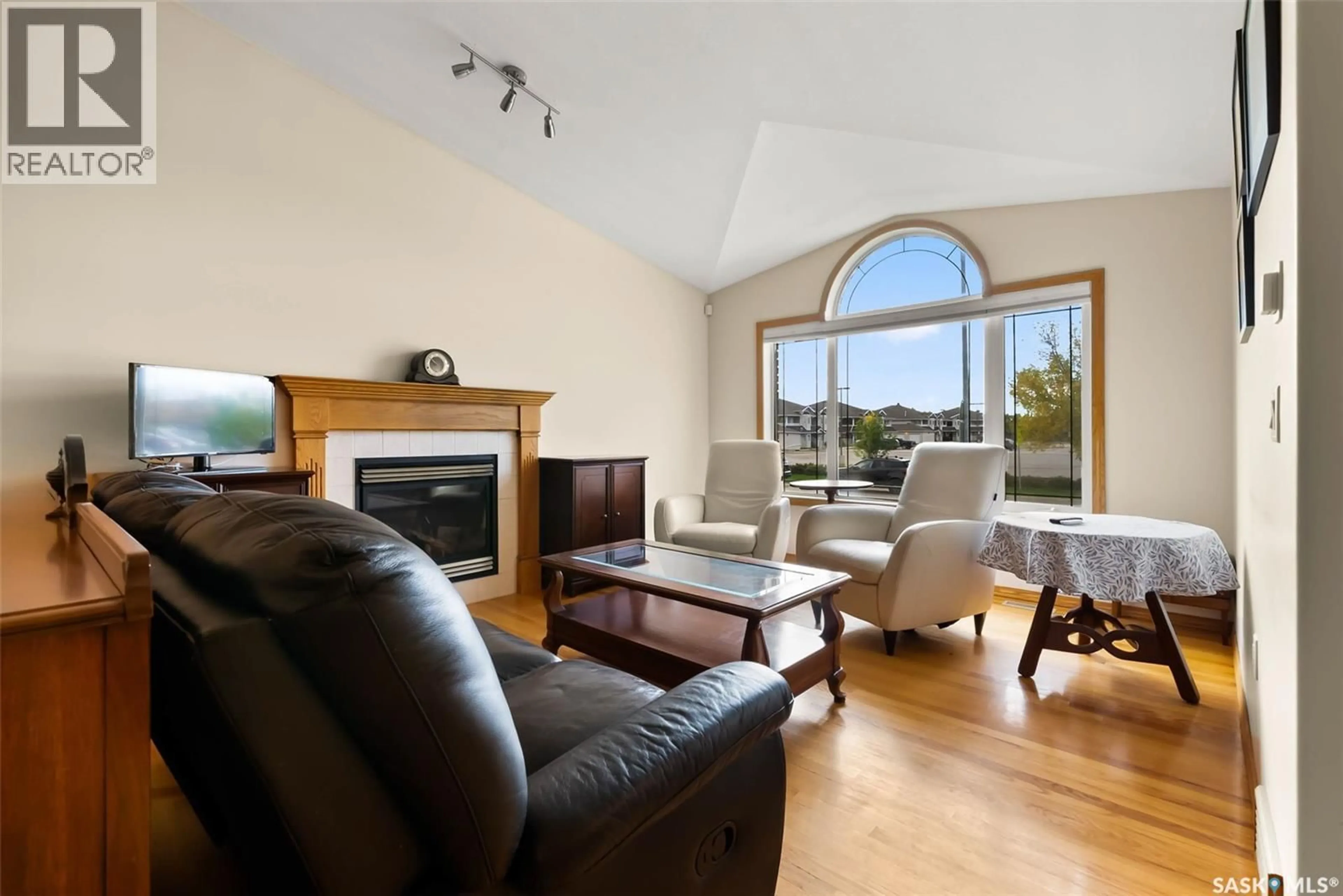 Living room with furniture, wood/laminate floor for 3086 CRANBOURN CRESCENT, Regina Saskatchewan S4V3B3