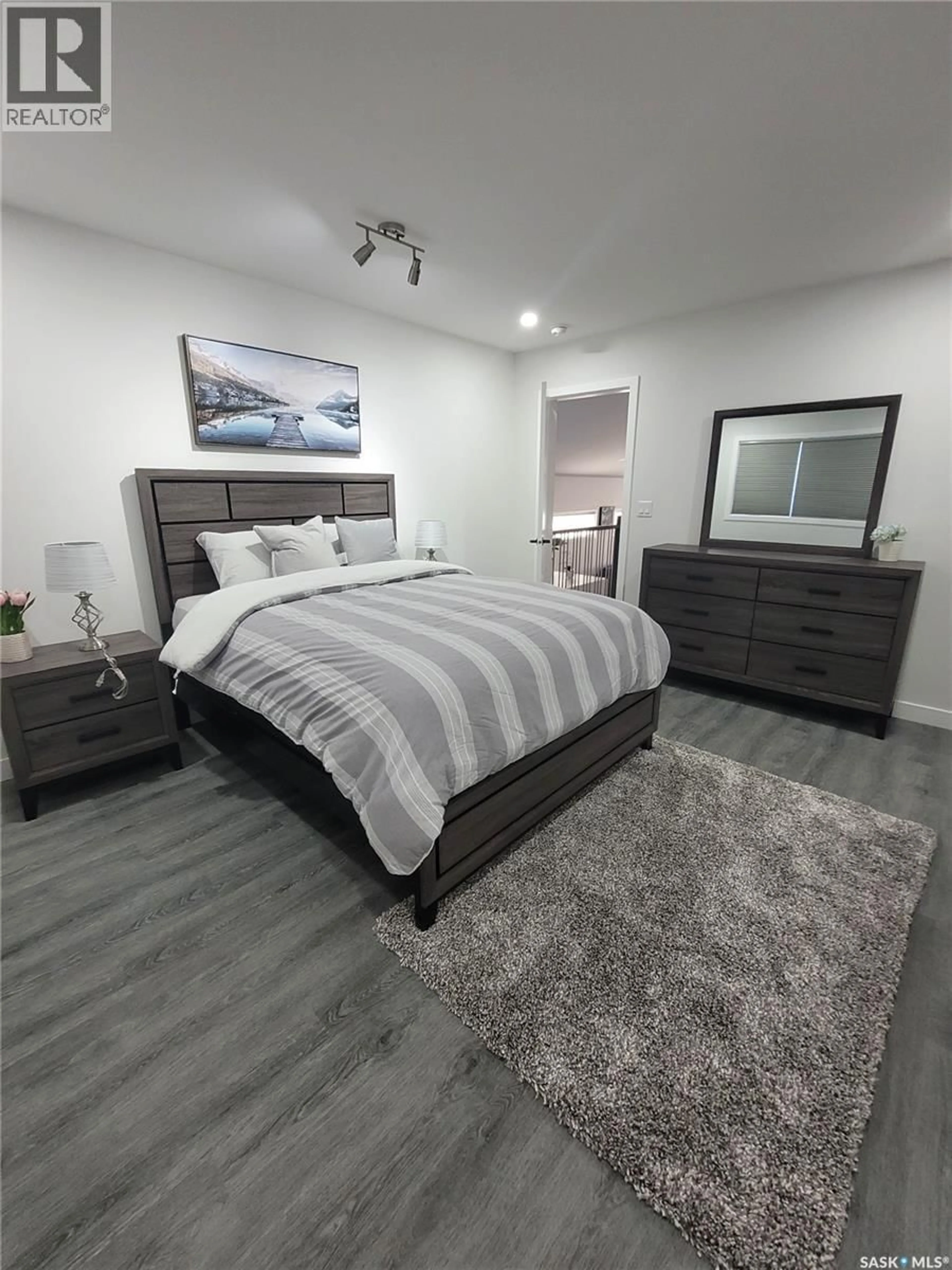 Bedroom with bed, wood/laminate floor for 539 ELLS CRESCENT, Saskatoon Saskatchewan S7L6K8
