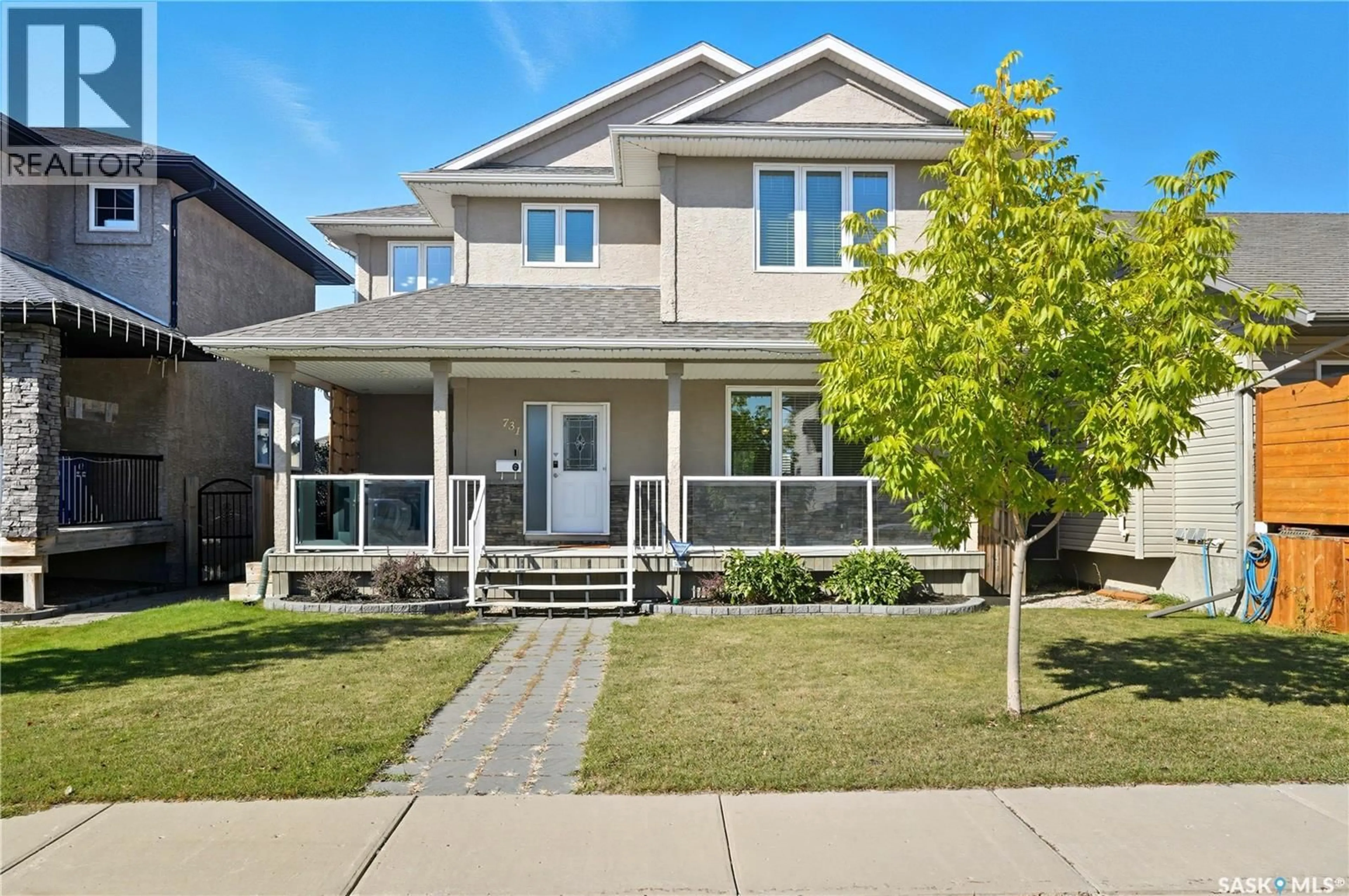 Home with vinyl exterior material, street for 731 WILLOWGROVE AVENUE, Saskatoon Saskatchewan S7W0A9