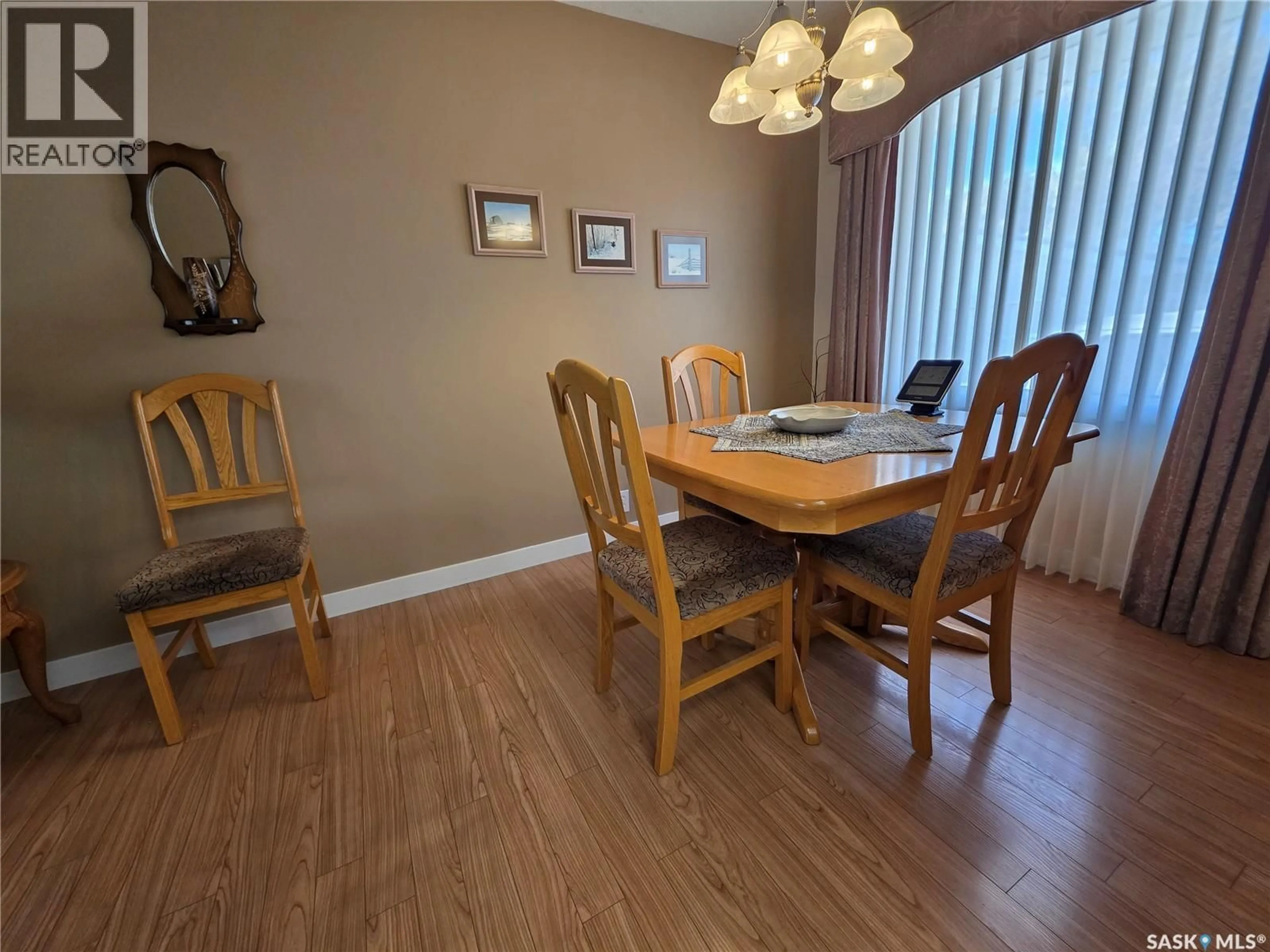 Dining room, wood/laminate floor for 810 11TH AVENUE, Swift Current Saskatchewan S9H2V4