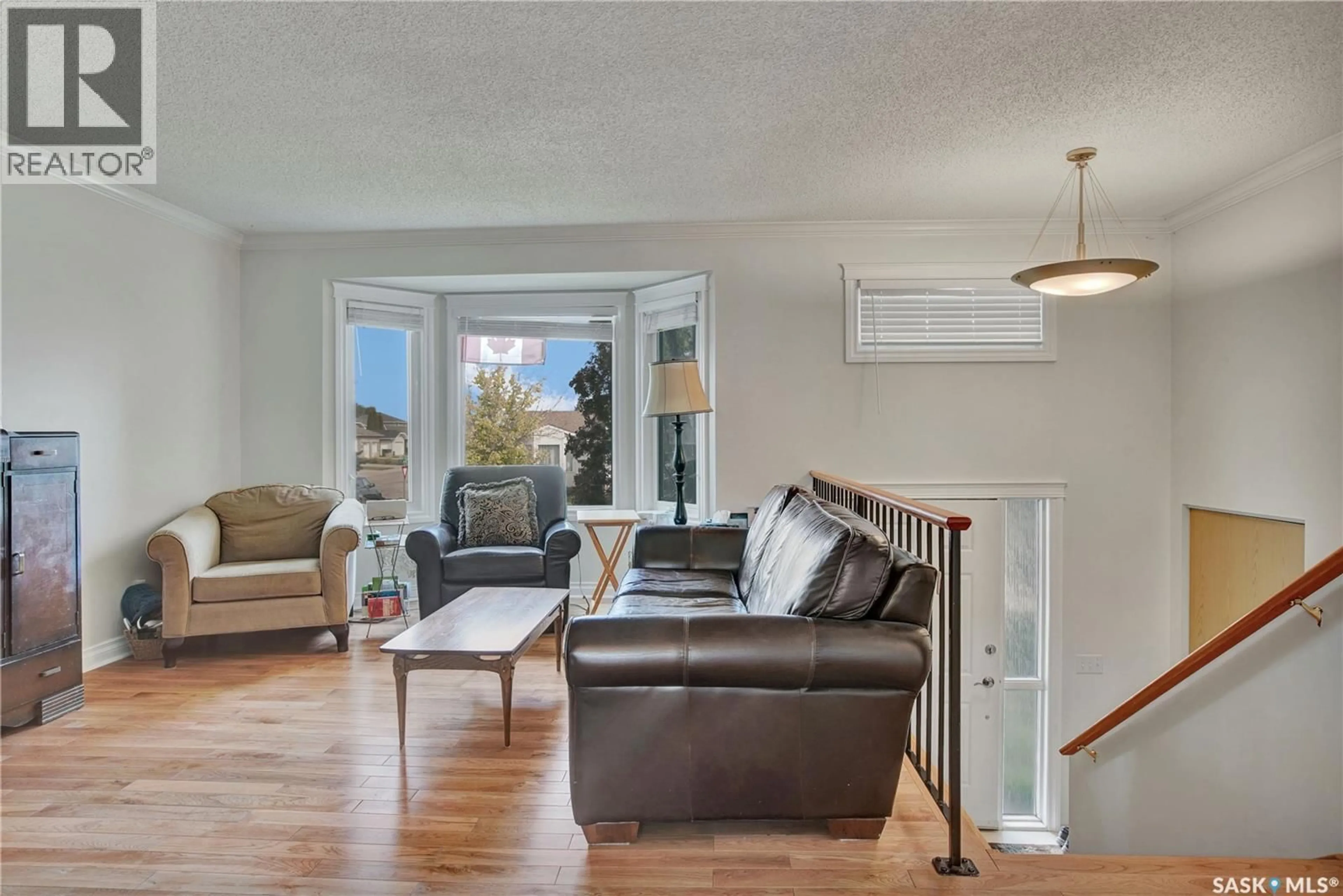 Living room with furniture, wood/laminate floor for 426 4TH AVENUE, Martensville Saskatchewan S0K2T2