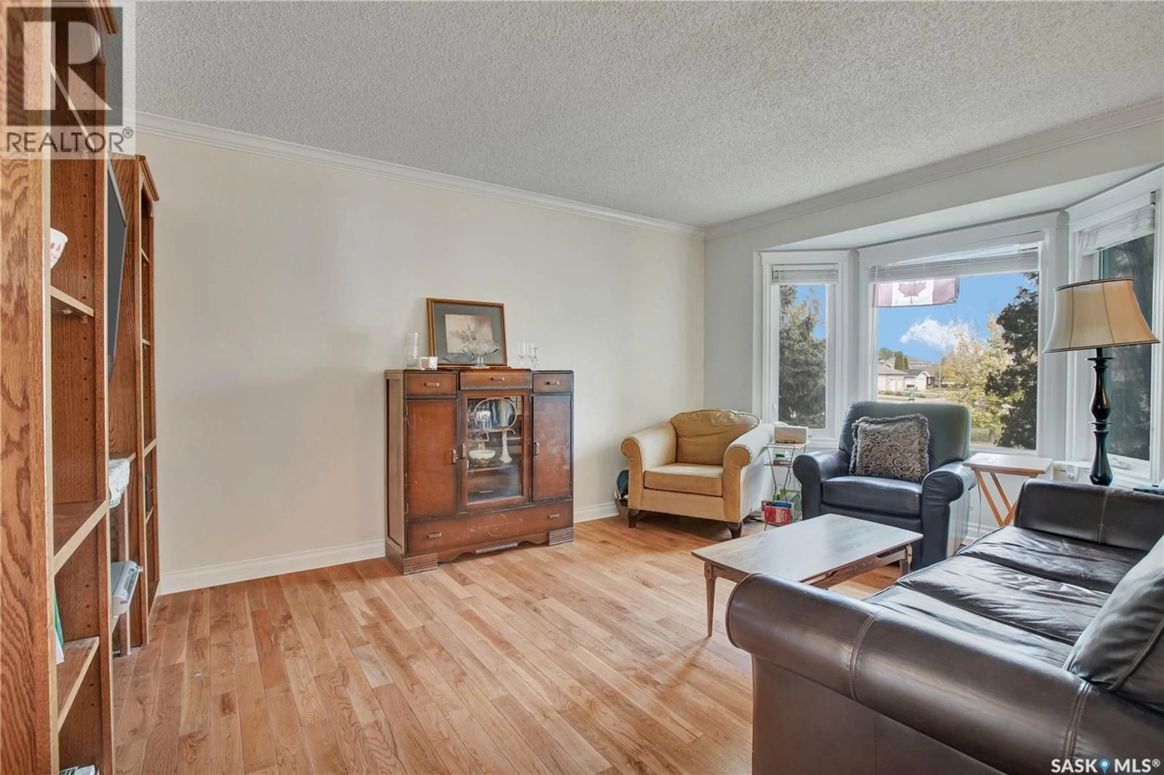 Living room with furniture, wood/laminate floor for 426 4TH AVENUE, Martensville Saskatchewan S0K2T2