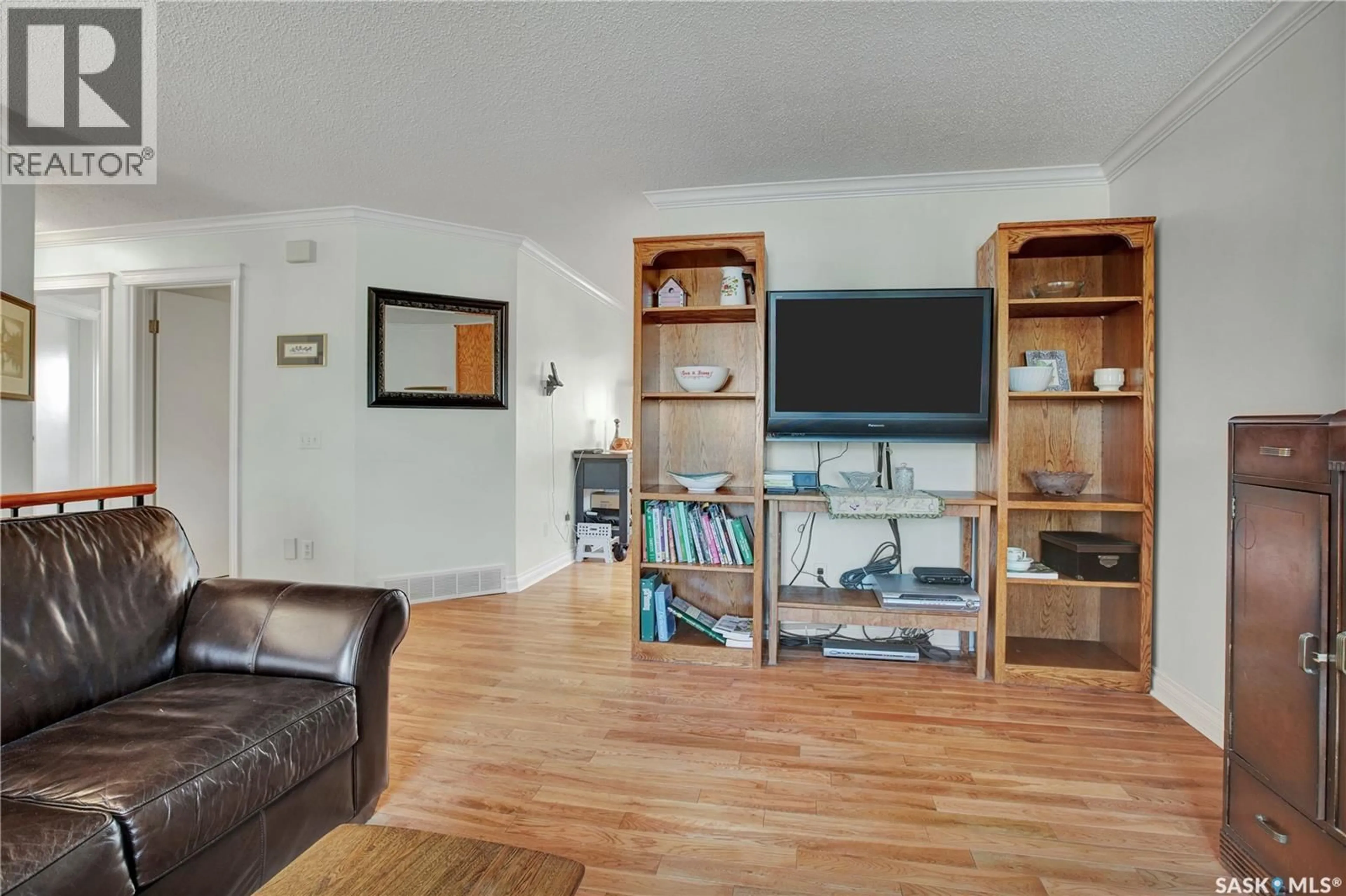Living room with furniture, wood/laminate floor for 426 4TH AVENUE, Martensville Saskatchewan S0K2T2