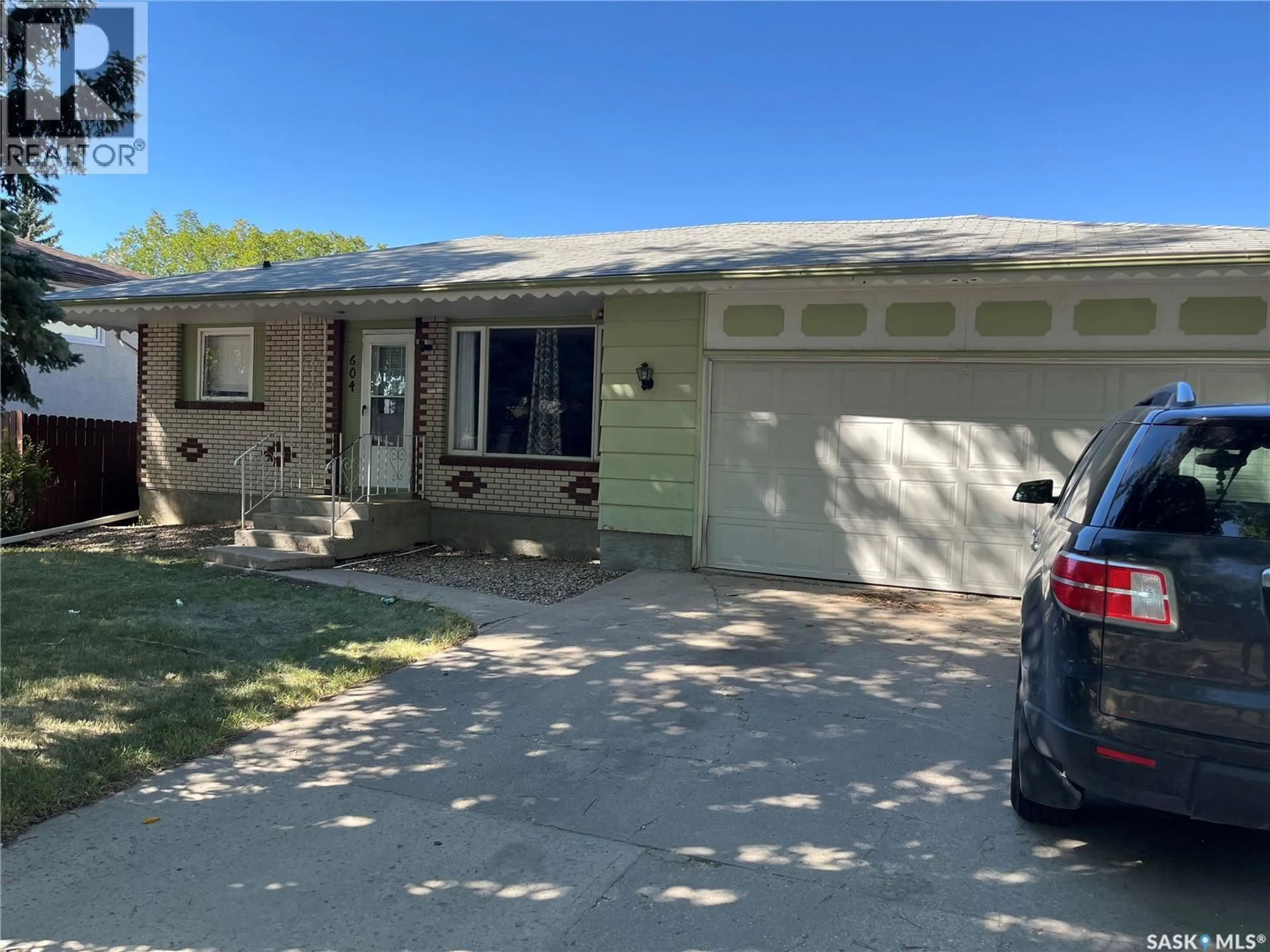 Home with vinyl exterior material, street for 604 DALGLIESH DRIVE, Regina Saskatchewan S4R6L8
