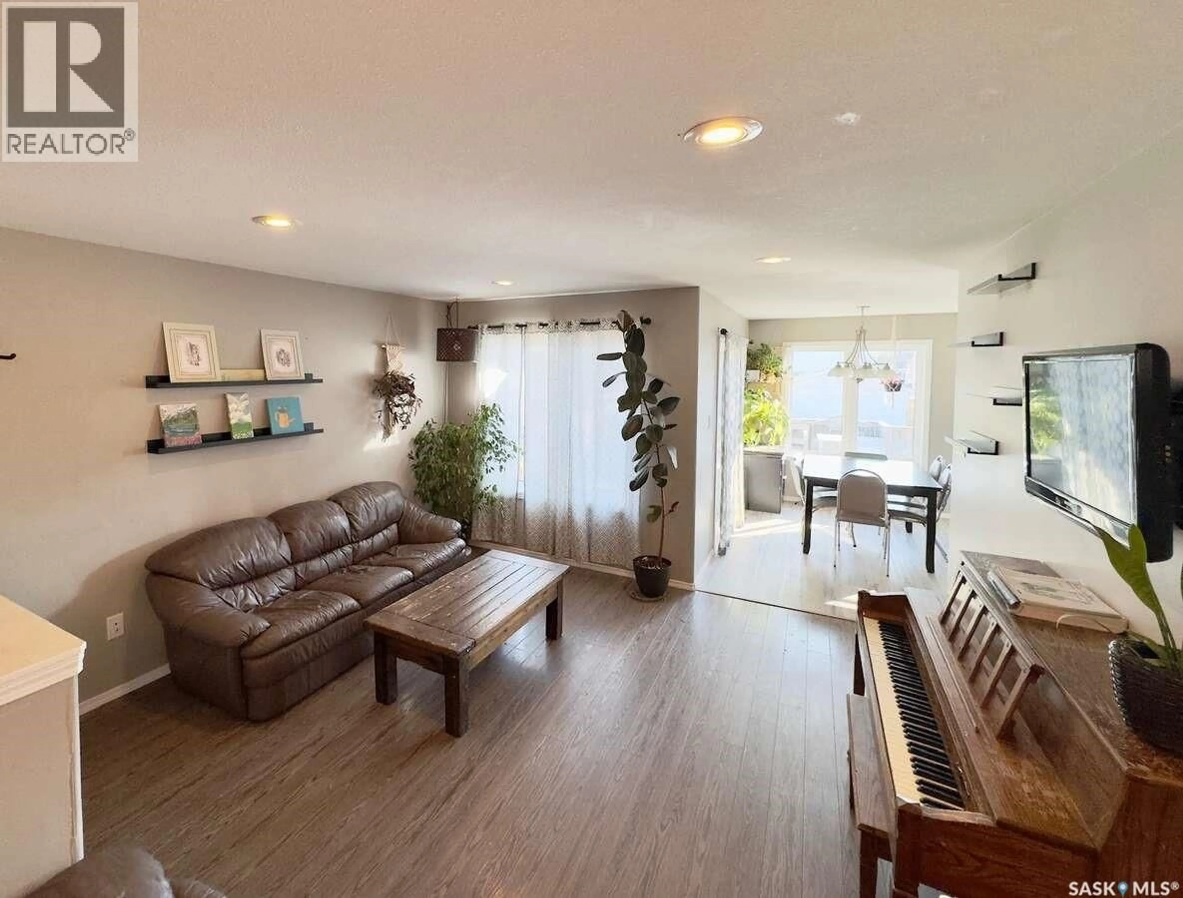 Living room with furniture, wood/laminate floor for 121 MARTENS CRESCENT, Warman Saskatchewan S0K4S3