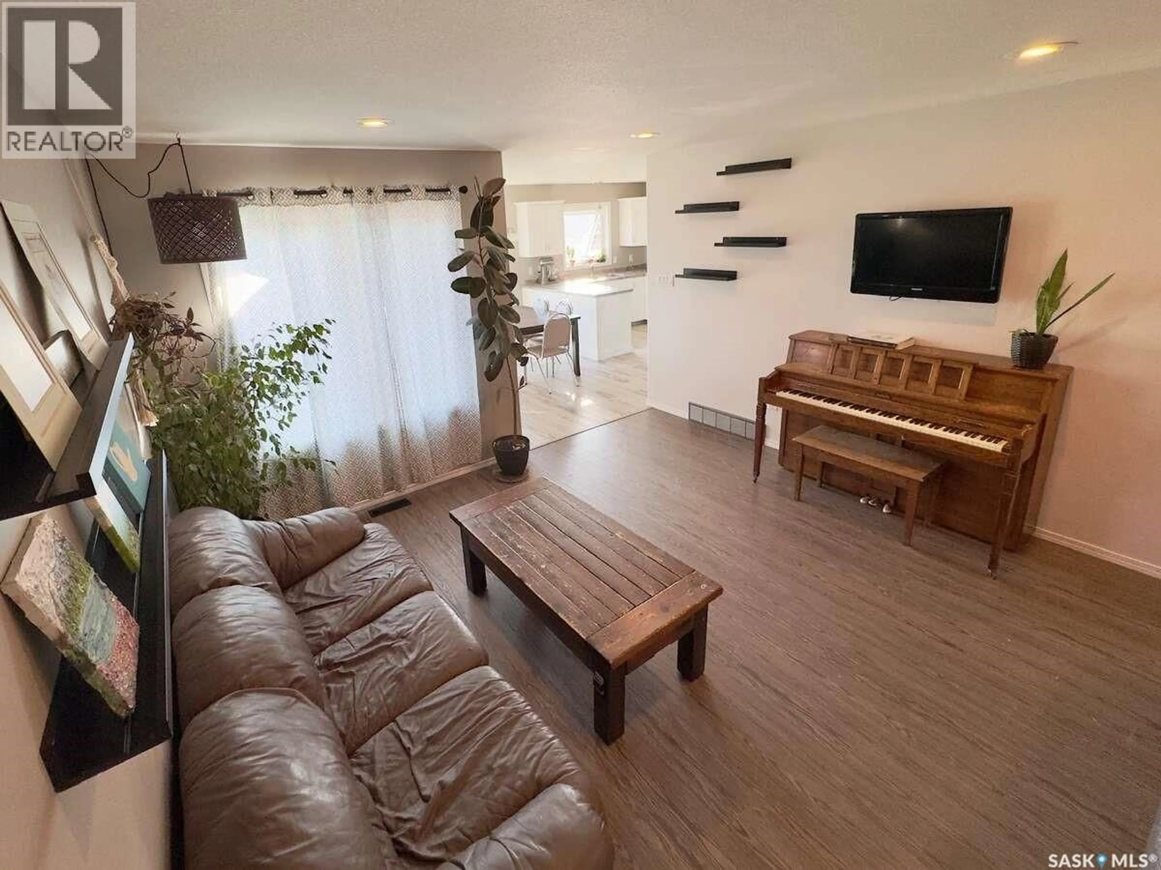 Living room with furniture, wood/laminate floor for 121 MARTENS CRESCENT, Warman Saskatchewan S0K4S3