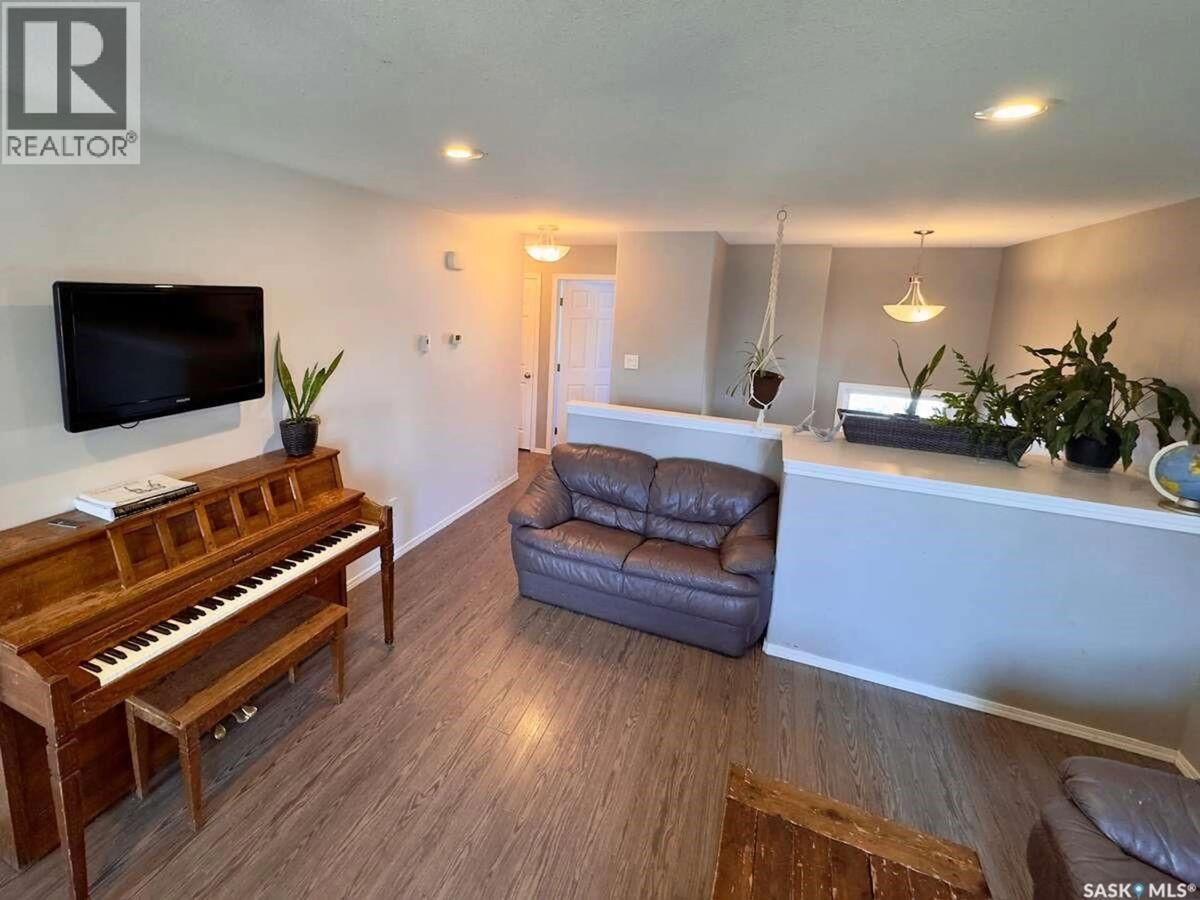 Living room with furniture, wood/laminate floor for 121 MARTENS CRESCENT, Warman Saskatchewan S0K4S3