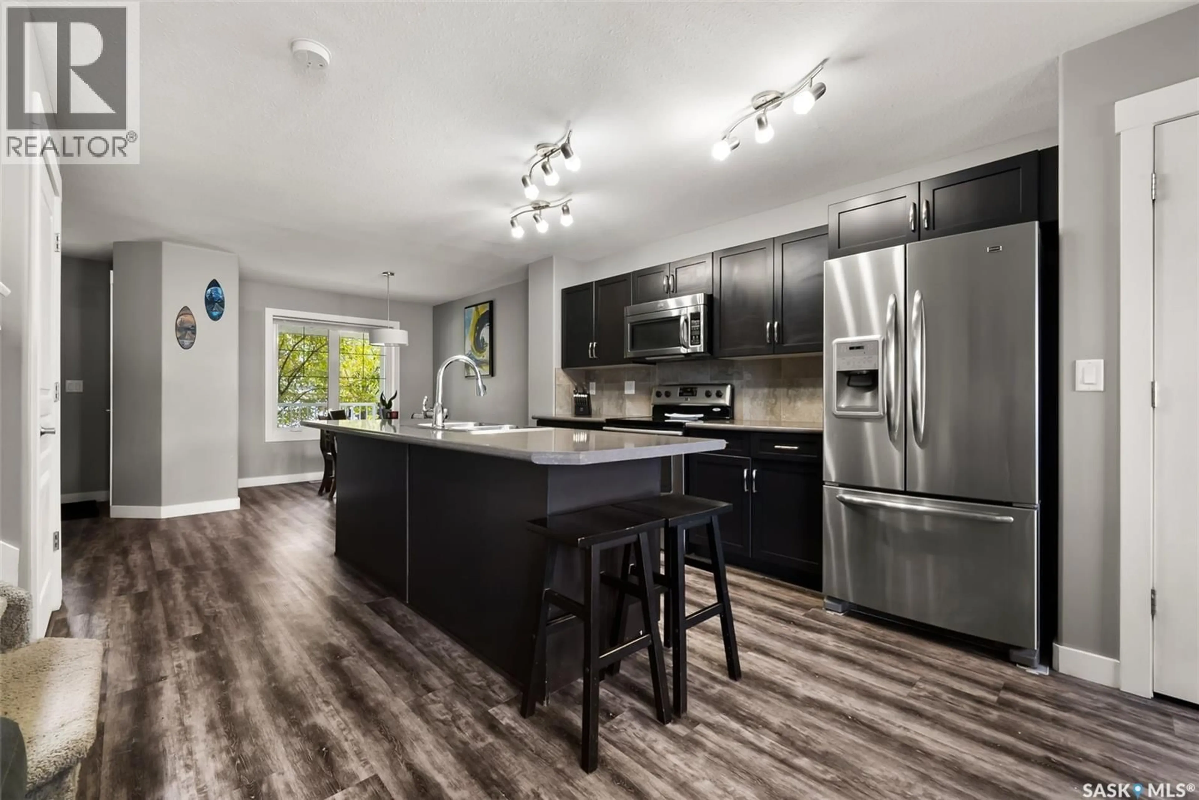Open concept kitchen, wood/laminate floor for 5330 UNIVERSAL CRESCENT, Regina Saskatchewan S4W0K7