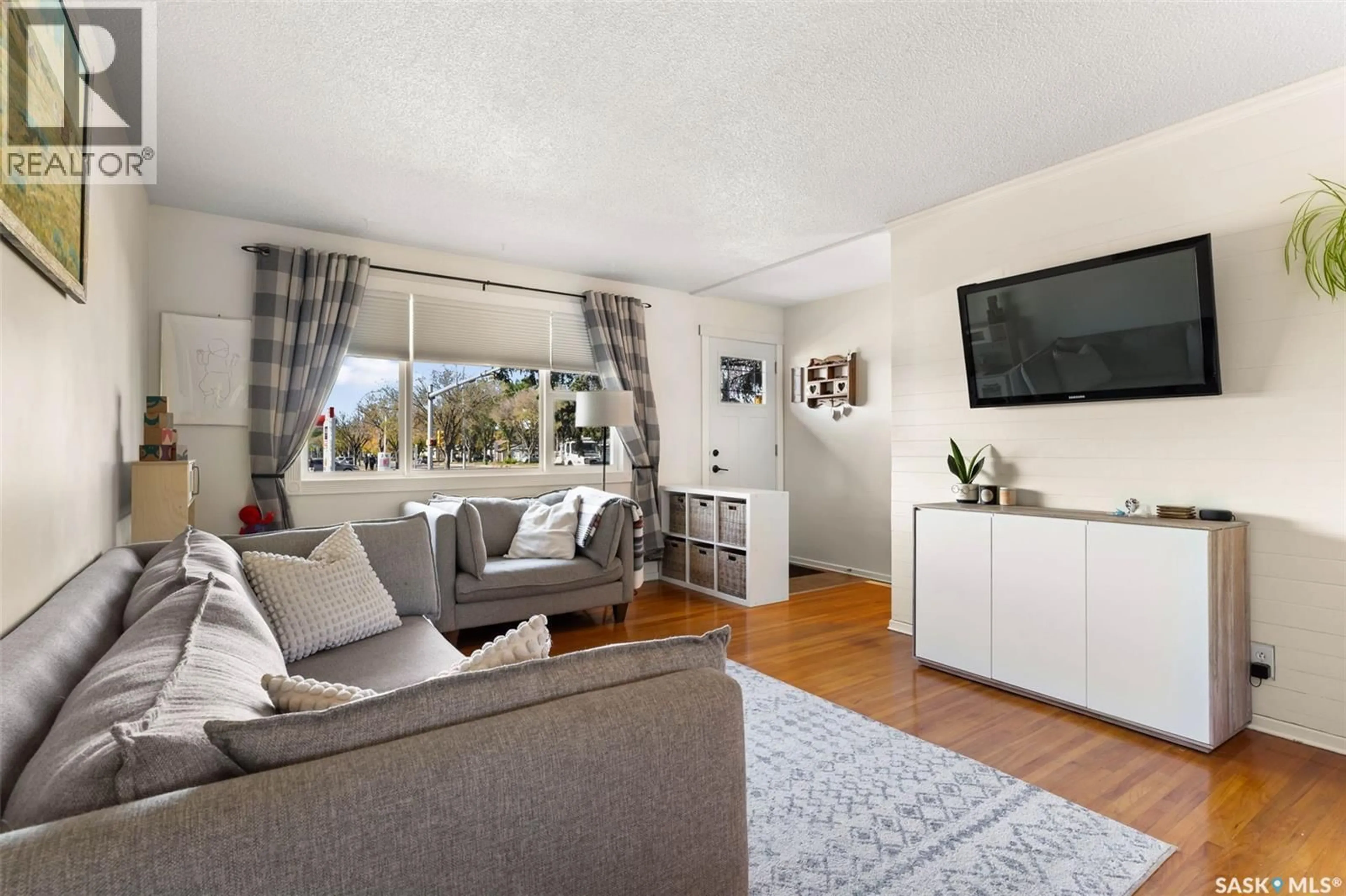 Living room with furniture, wood/laminate floor for 211 ARGYLE STREET, Regina Saskatchewan S4R4C5