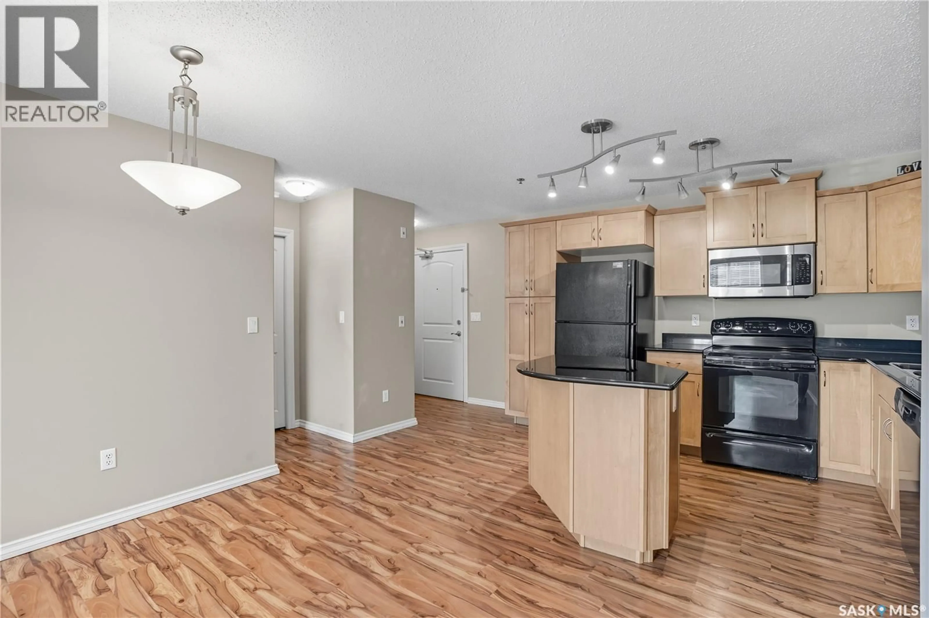Open concept kitchen, wood/laminate floor for B103 - 103 WELLMAN CRESCENT, Saskatoon Saskatchewan S7T0C1