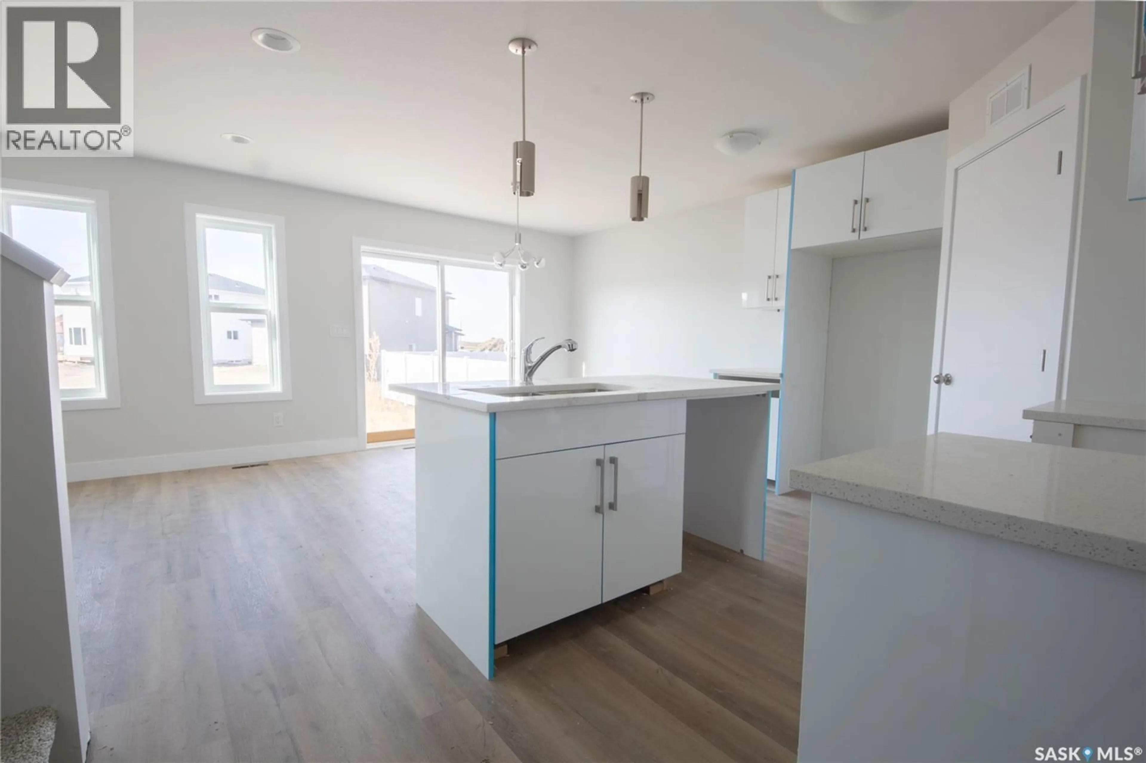 Open concept kitchen, wood/laminate floor for 111 STROMBERG CRESCENT, Saskatoon Saskatchewan S7L7C4