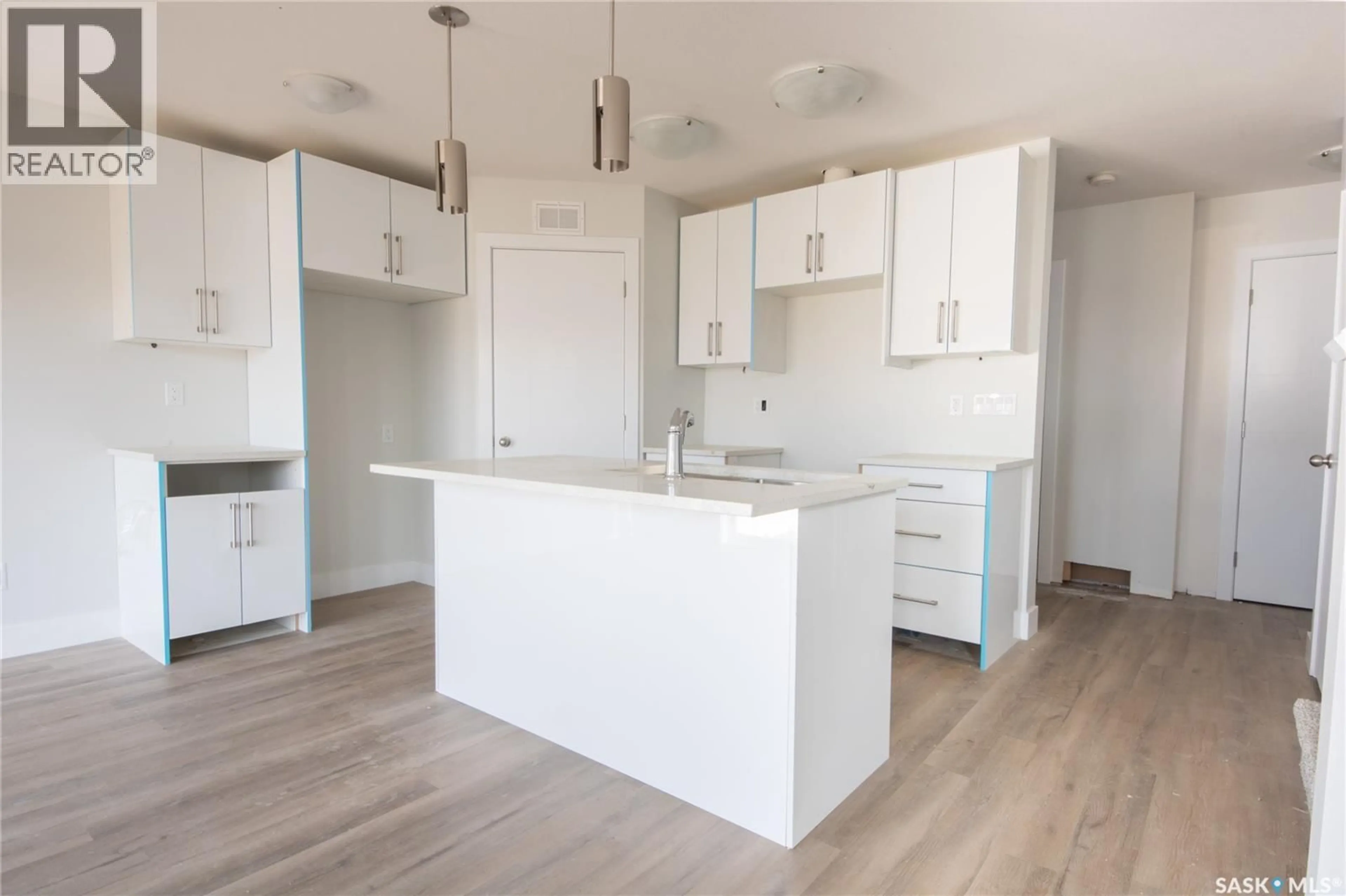 Open concept kitchen, wood/laminate floor for 111 STROMBERG CRESCENT, Saskatoon Saskatchewan S7L7C4