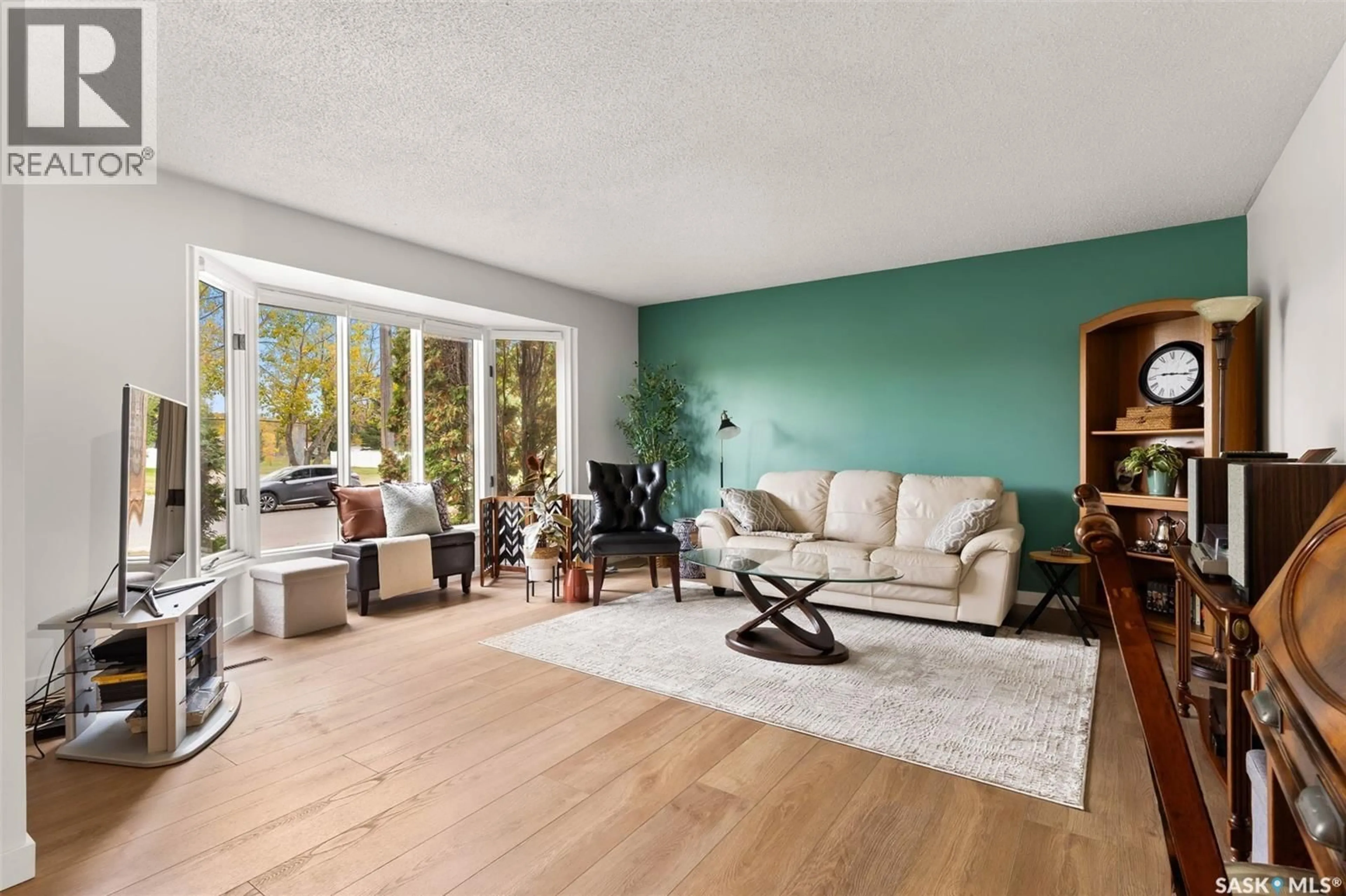 Living room with furniture, wood/laminate floor for 7 NORRIS ROAD, Regina Saskatchewan S4S5N1