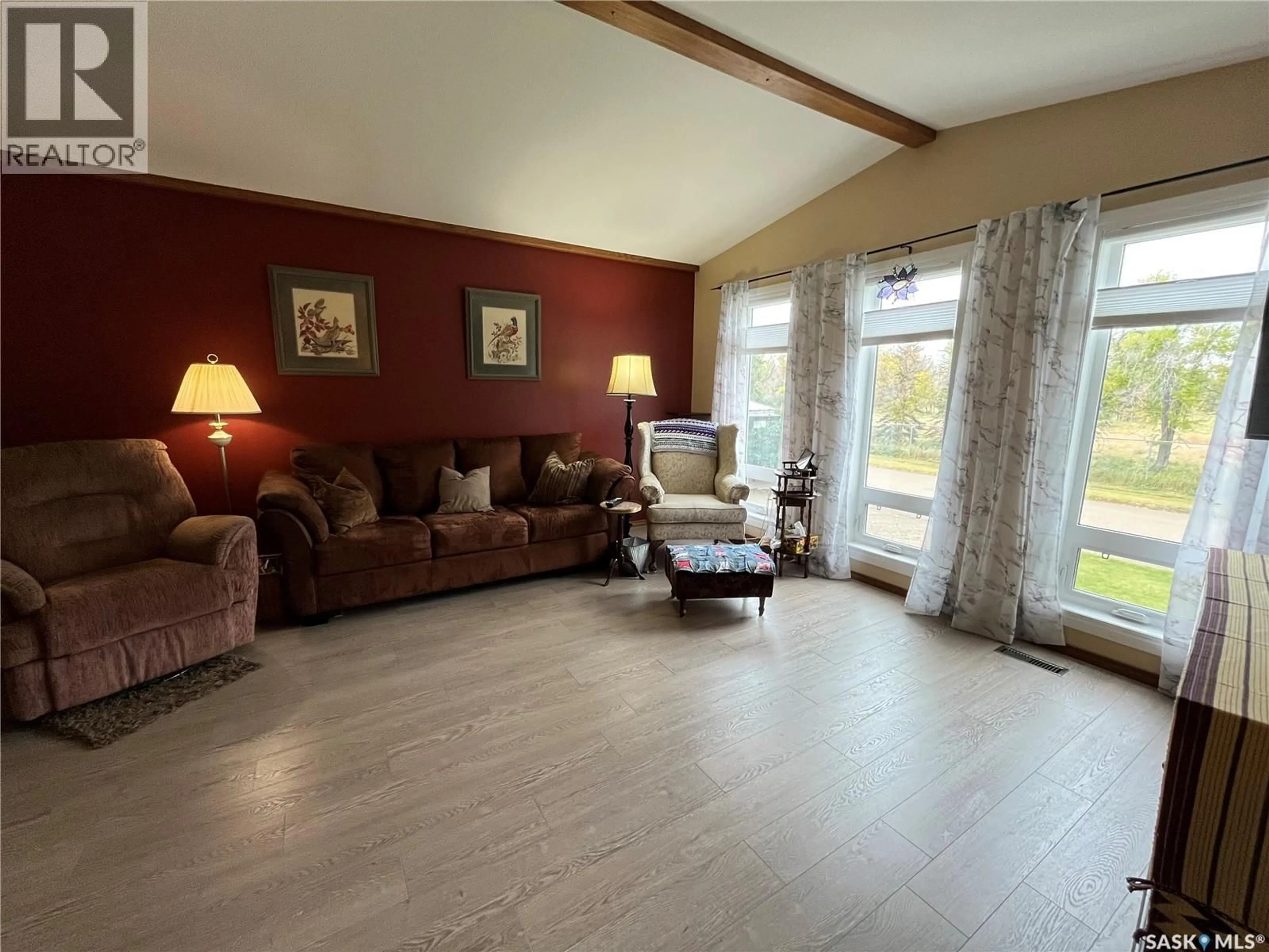 Living room with furniture, wood/laminate floor for 11 2ND AVENUE, Maple Creek Saskatchewan S0N1N0