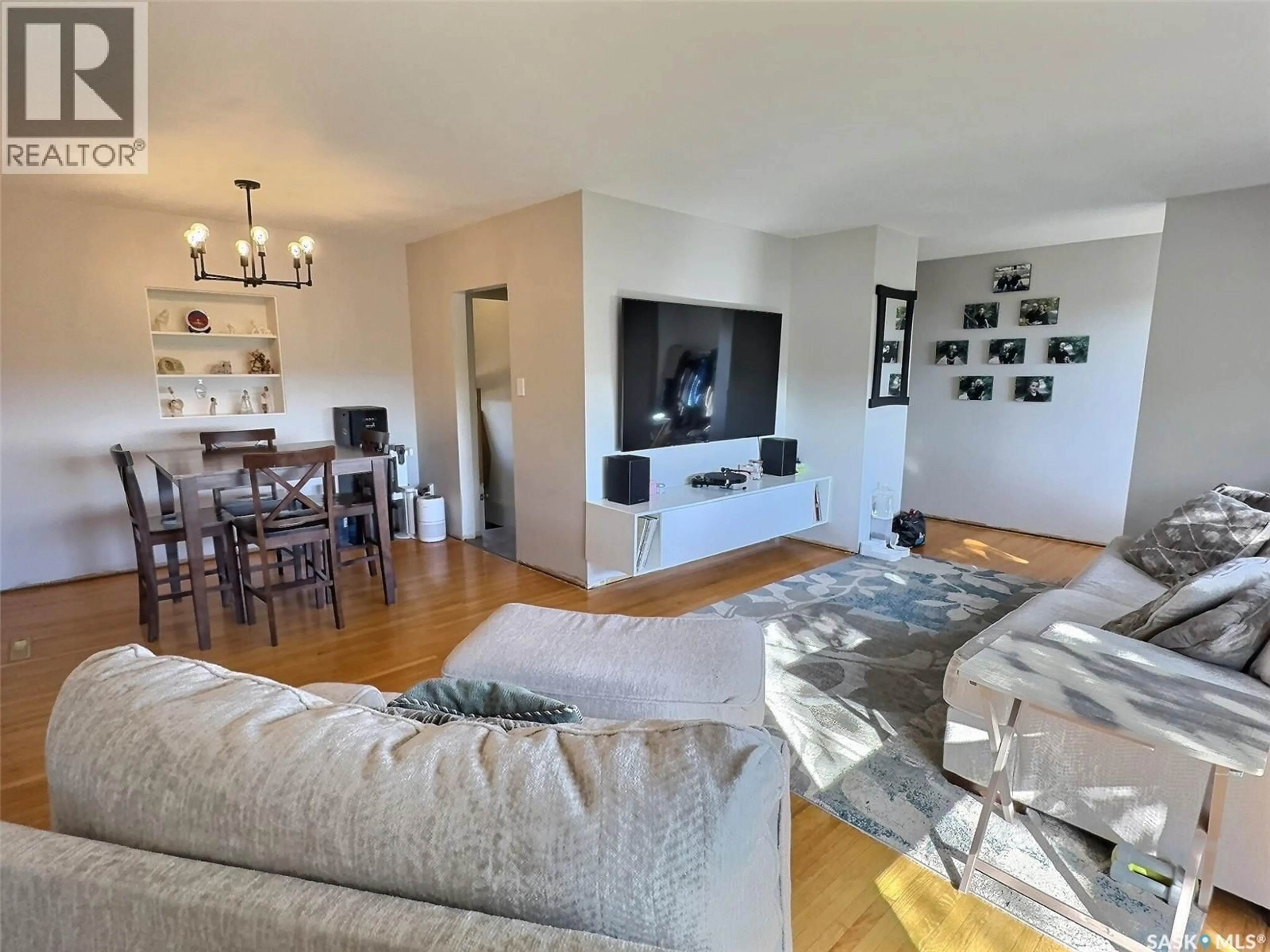 Living room with furniture, wood/laminate floor for 1727 FIRST STREET, Estevan Saskatchewan S4A0H6