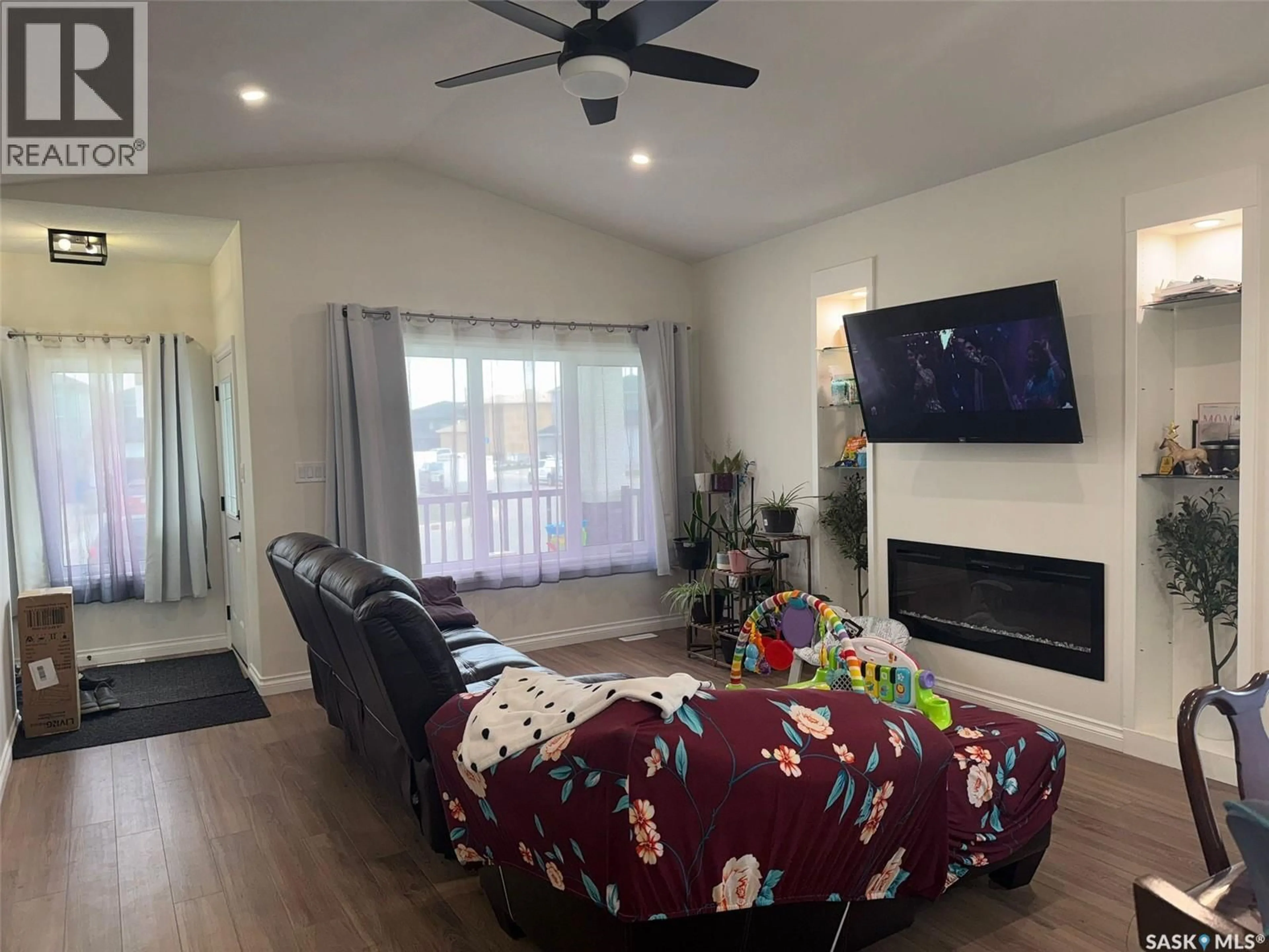 Living room with furniture, wood/laminate floor for 5400 BOYER BAY, Regina Saskatchewan S4V3P2