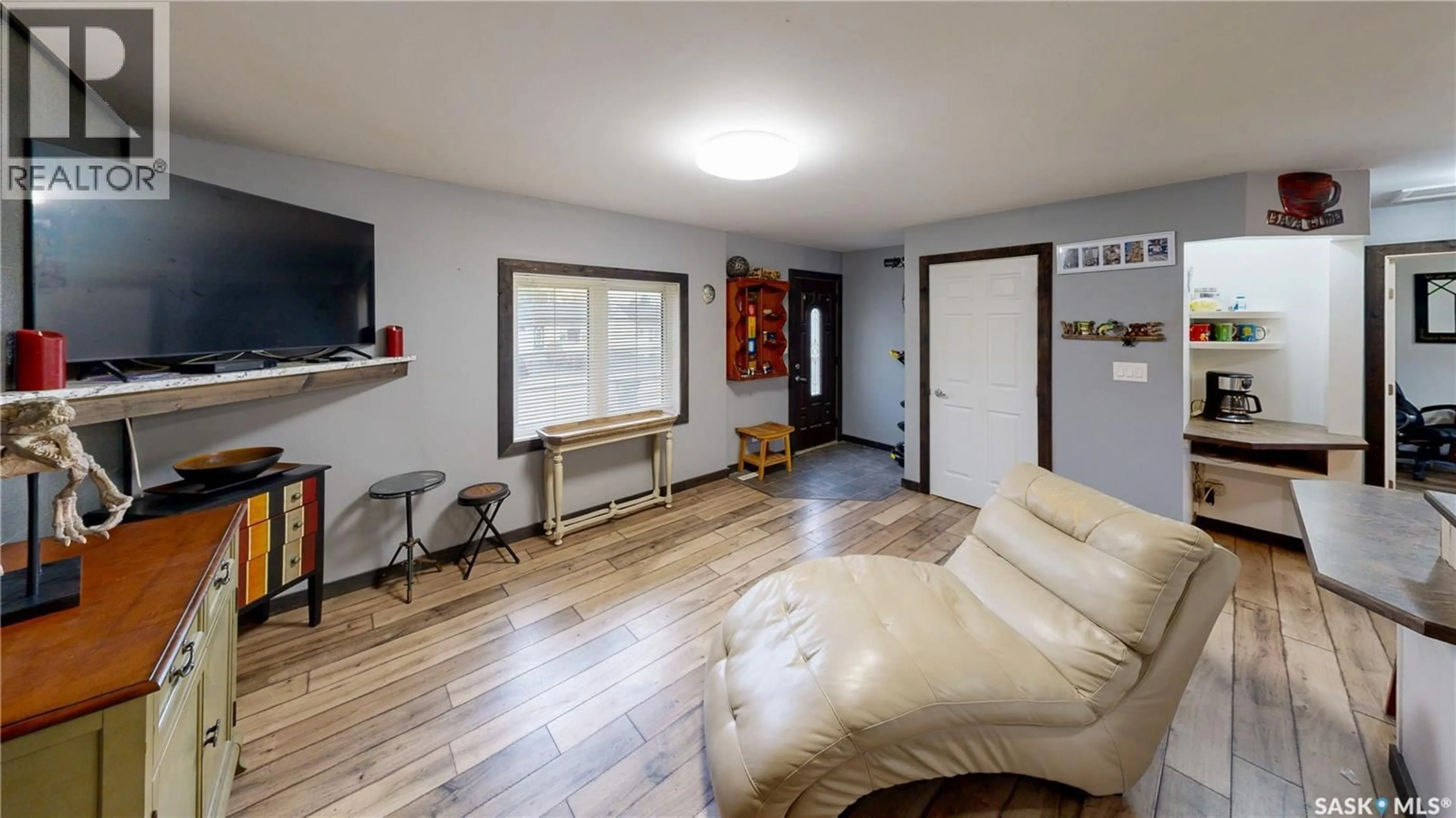 Living room with furniture, wood/laminate floor for 31 JARVIS STREET, Qu'Appelle Saskatchewan S0G4A0