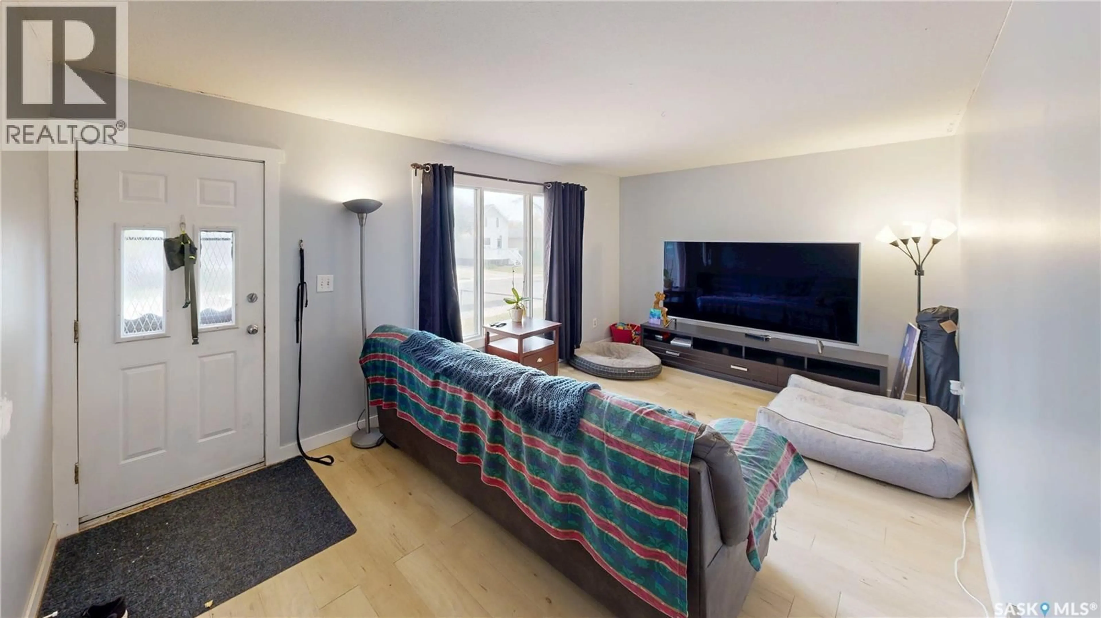 Living room with furniture, wood/laminate floor for 2130 ATKINSON STREET, Regina Saskatchewan S4N3W9