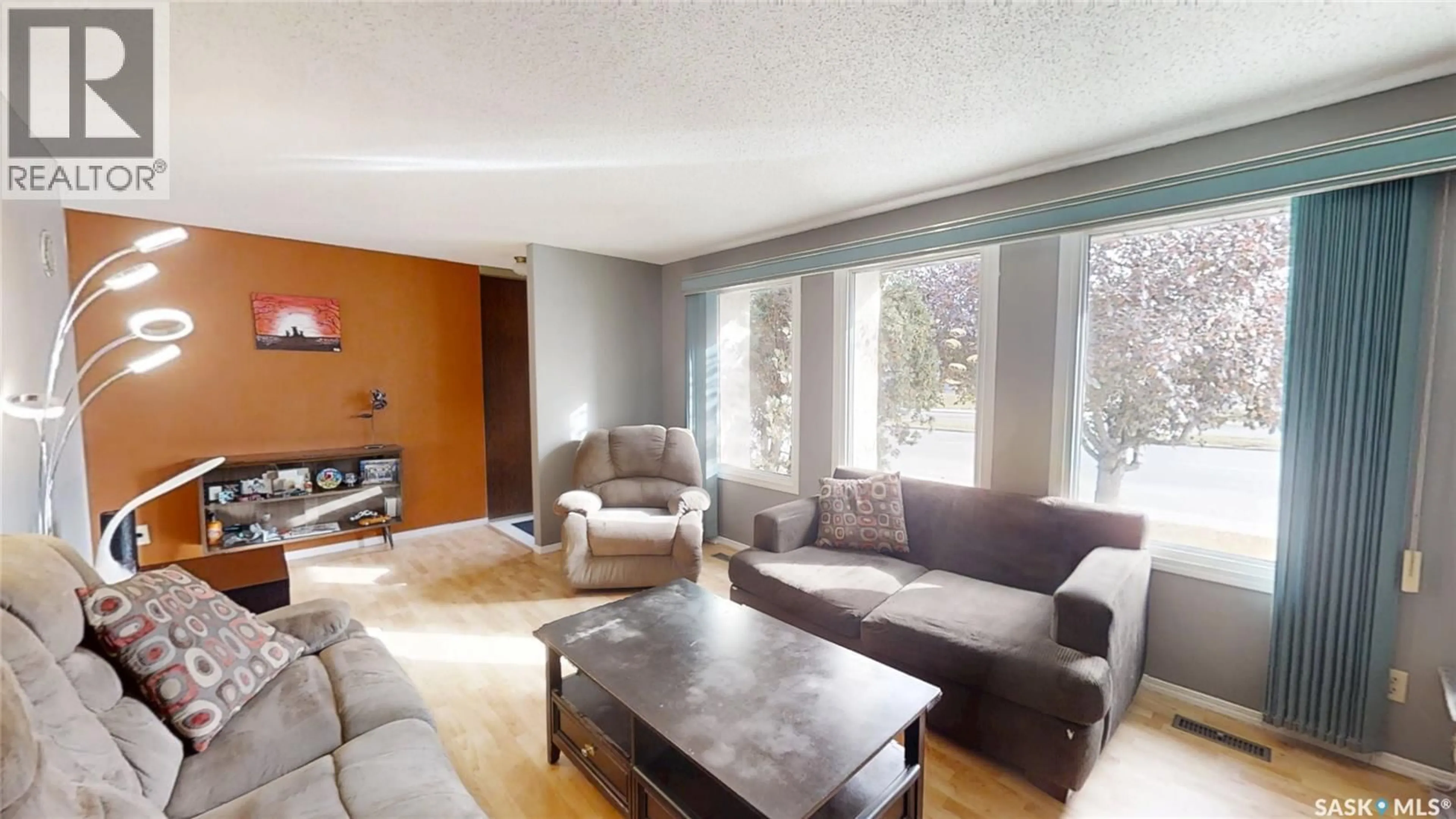 Living room with furniture, wood/laminate floor for 1214 MCKERCHER DRIVE, Saskatoon Saskatchewan S7H4Y7