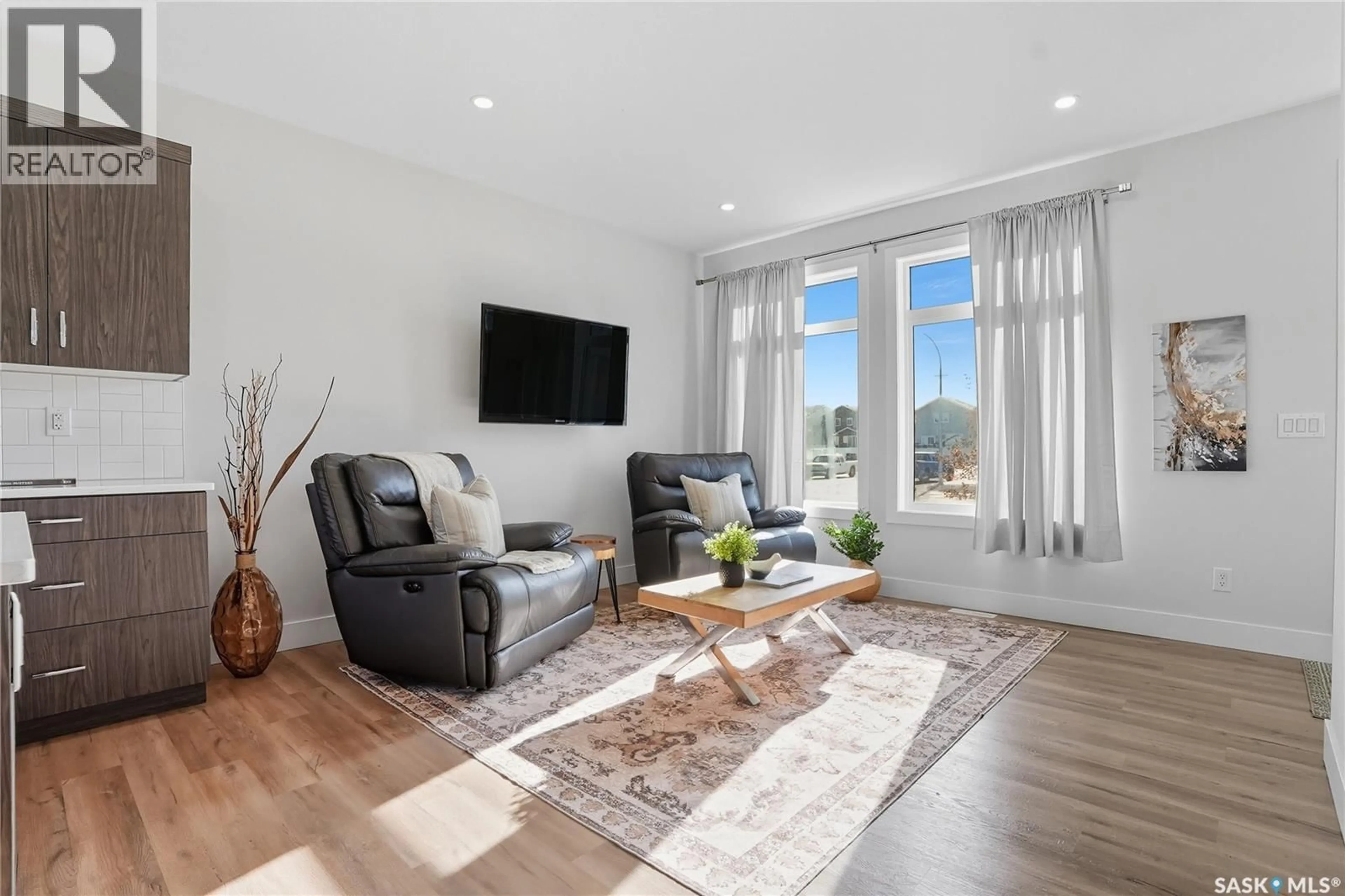 Living room with furniture, wood/laminate floor for 723 HENRY DAYDAY ROAD, Saskatoon Saskatchewan S7W1H5