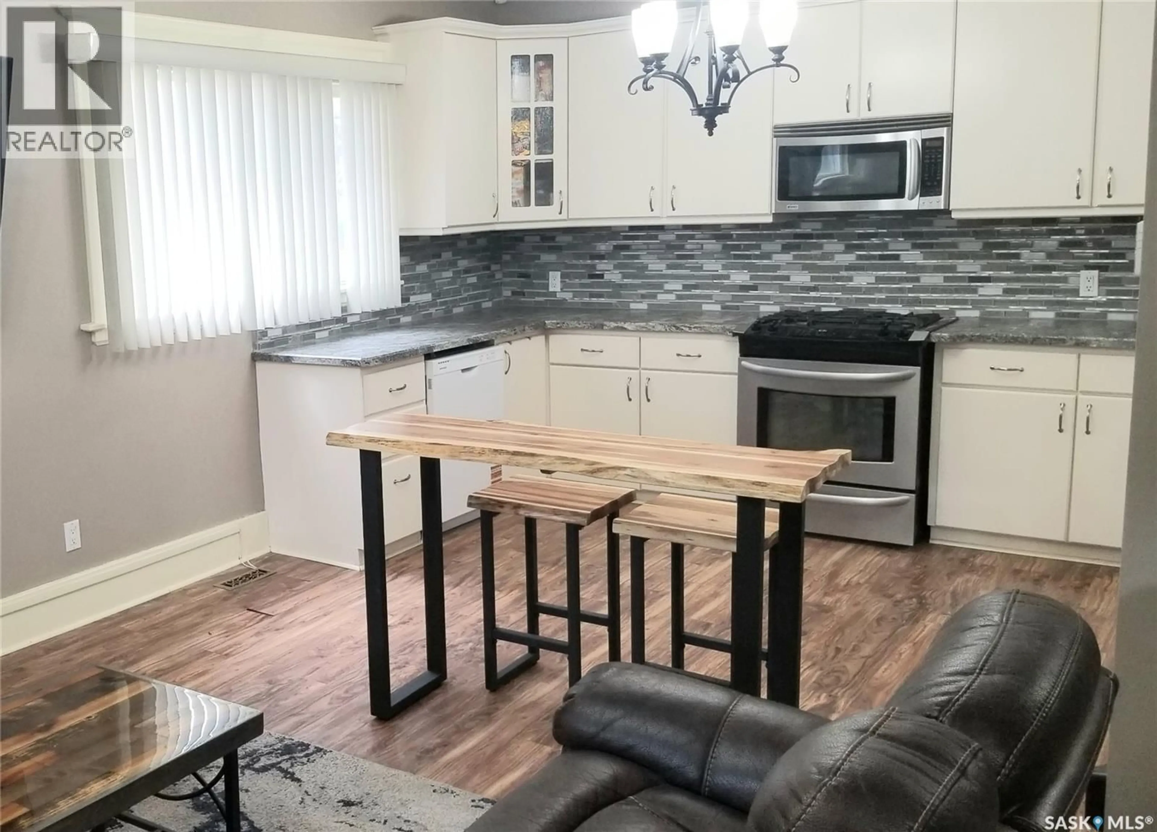 Open concept kitchen, wood/laminate floor for 1422 CAMERON STREET, Regina Saskatchewan S4T2T4