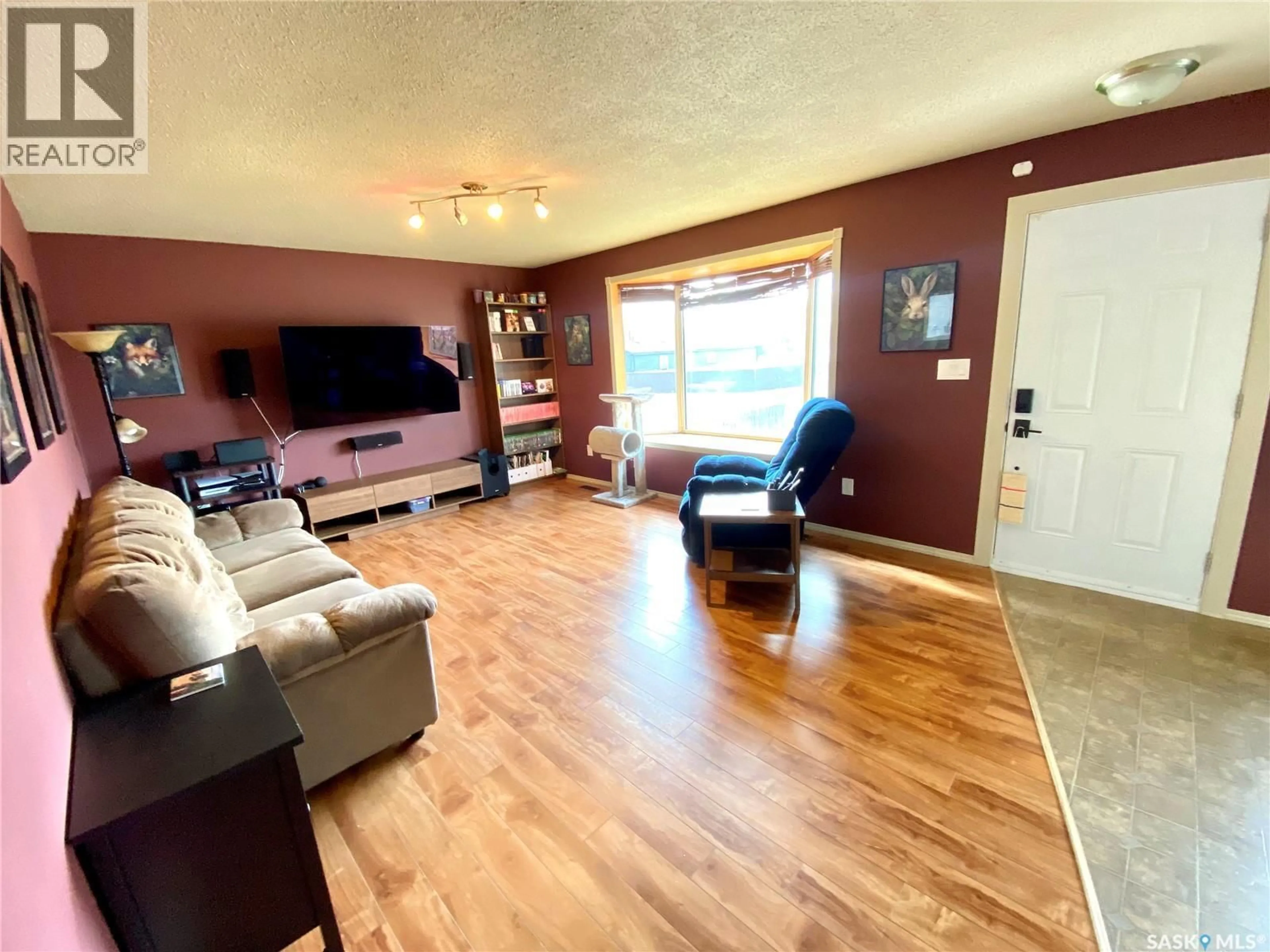 Living room with furniture, wood/laminate floor for 425 YOUNG STREET, Bienfait Saskatchewan S0C0M0