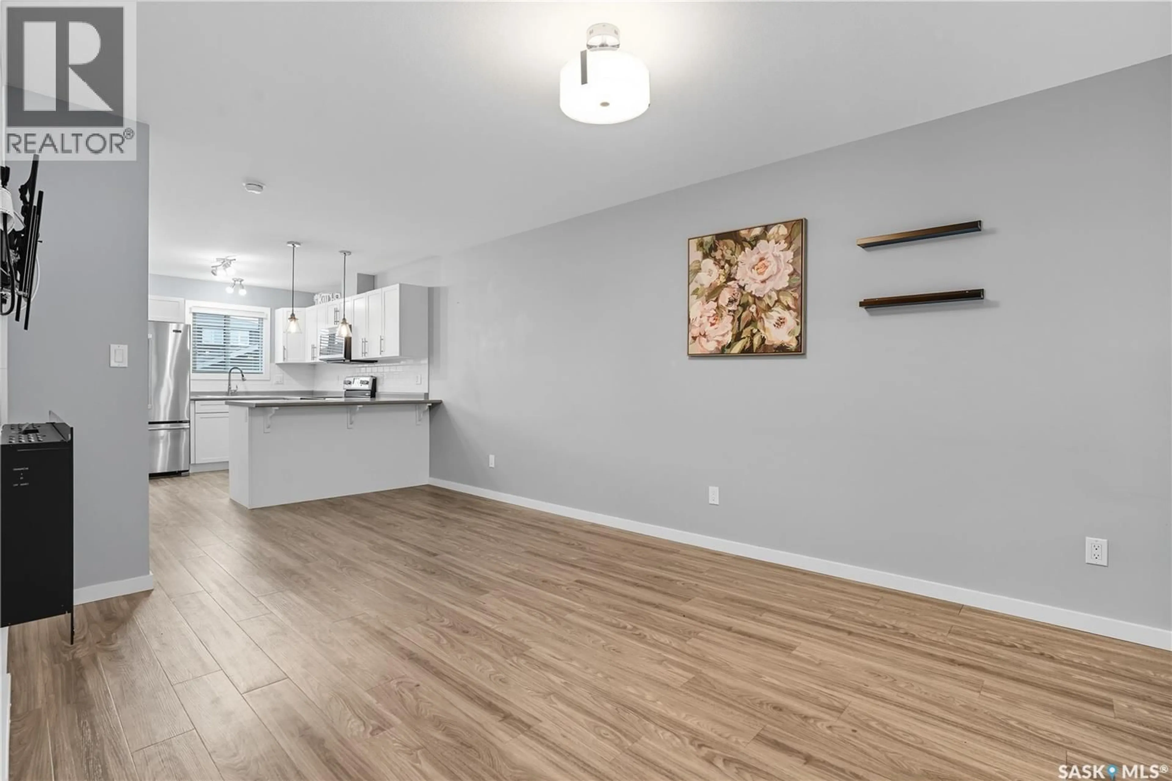 Open concept kitchen, wood/laminate floor for 4809 PRIMROSE GREEN DRIVE, Regina Saskatchewan S4V3L1