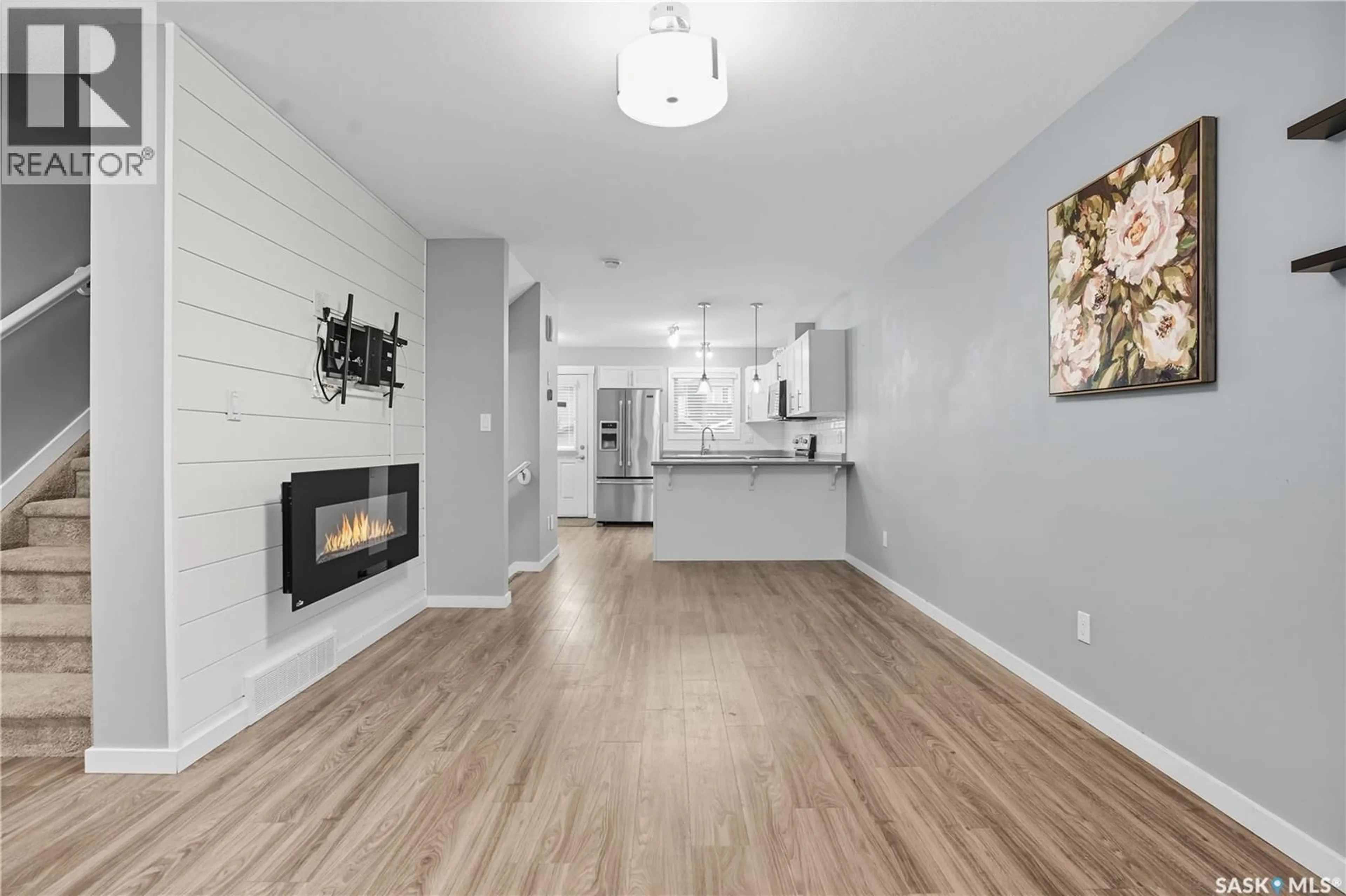 Open concept kitchen, wood/laminate floor for 4809 PRIMROSE GREEN DRIVE, Regina Saskatchewan S4V3L1