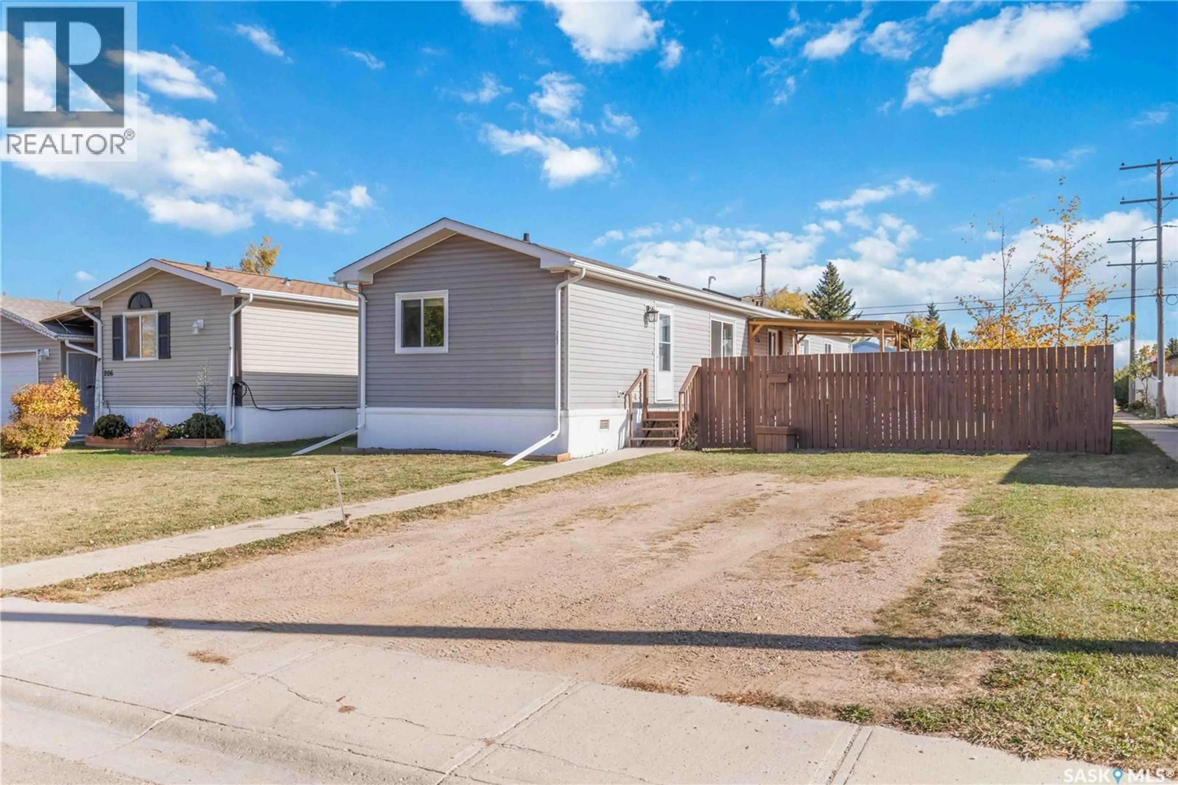 Home with vinyl exterior material, street for 202 14TH STREET, Humboldt Saskatchewan S0K2A0