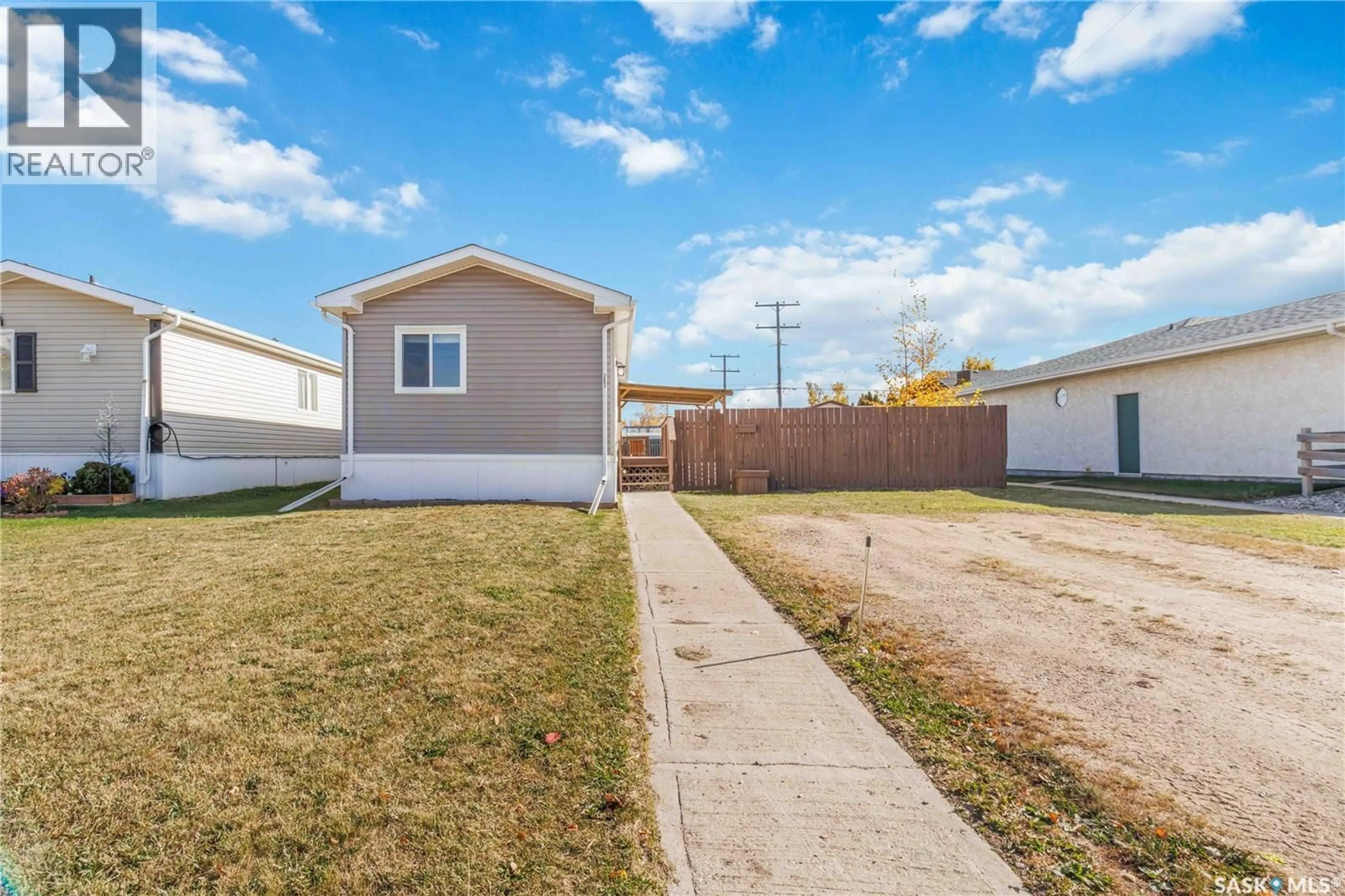 Home with vinyl exterior material, street for 202 14TH STREET, Humboldt Saskatchewan S0K2A0