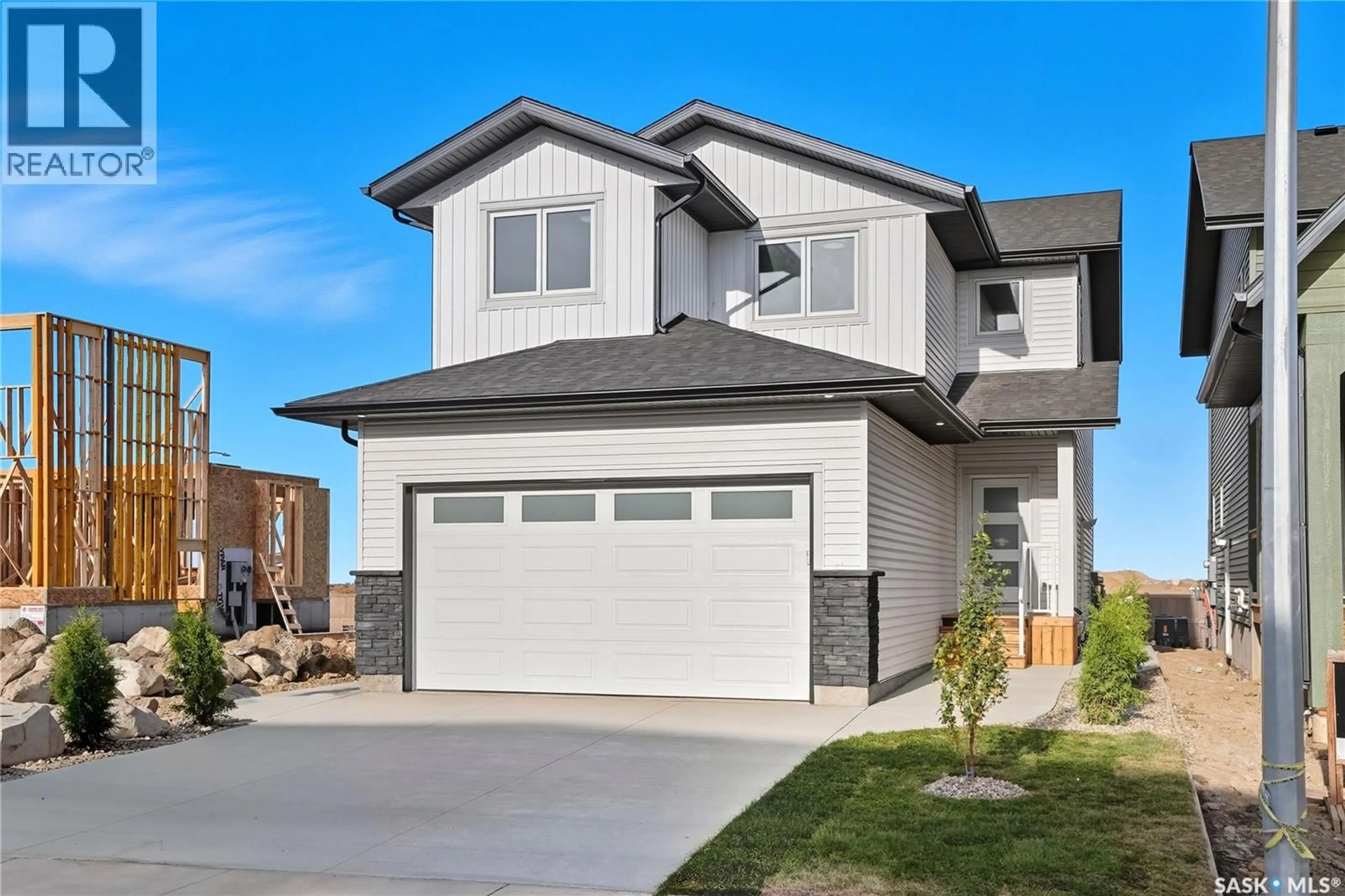 Home with vinyl exterior material, street for 311 SHARMA CRESCENT, Saskatoon Saskatchewan S7W1L1