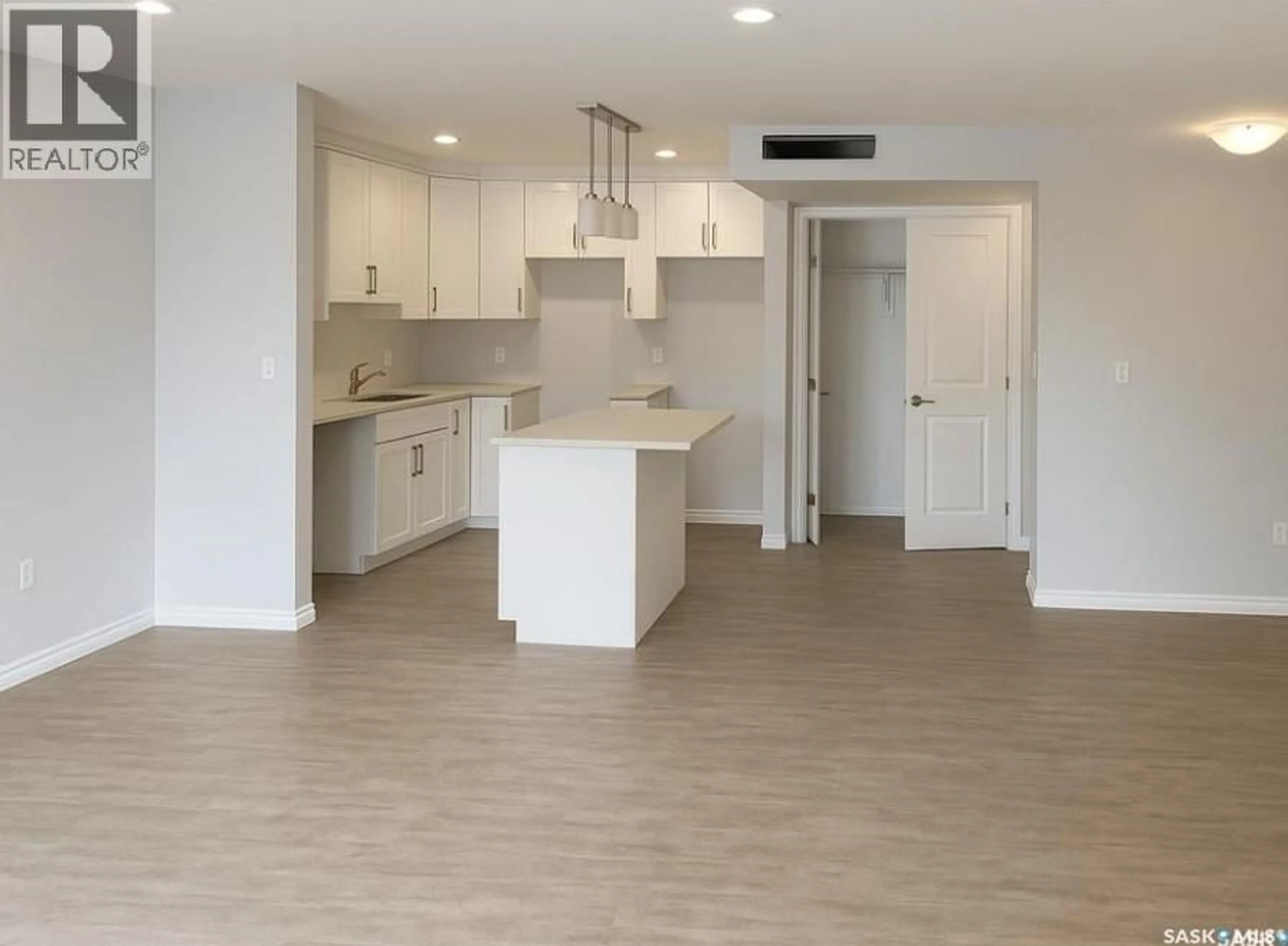 Open concept kitchen, wood/laminate floor for 101 - 318 108TH STREET, Saskatoon Saskatchewan S7N1P8