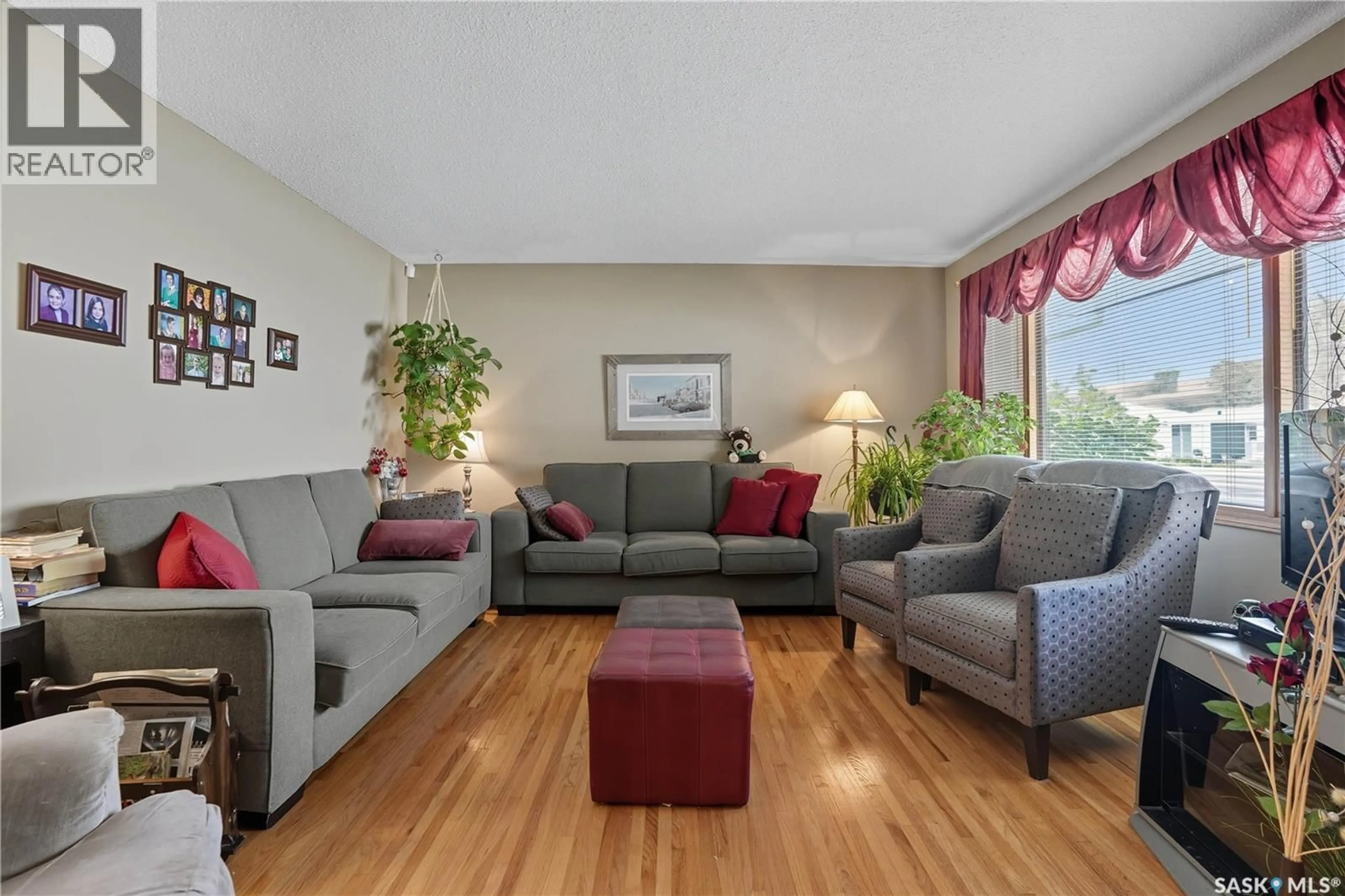 Living room with furniture, wood/laminate floor for 119 HAMMOND ROAD, Regina Saskatchewan S4R3C9
