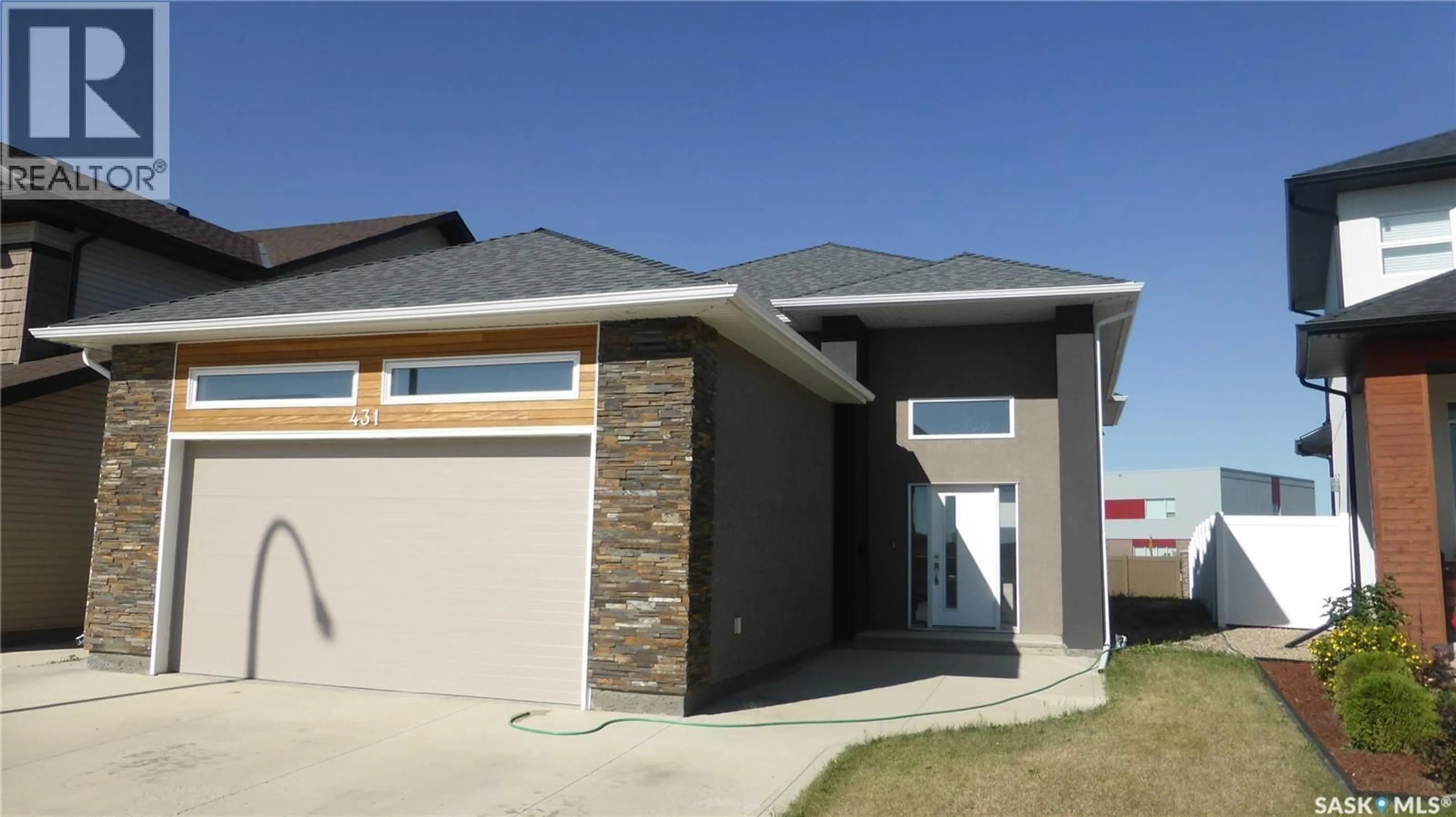 Home with brick exterior material, street for 431 FLYNN LANE, Saskatoon Saskatchewan S7V0J8