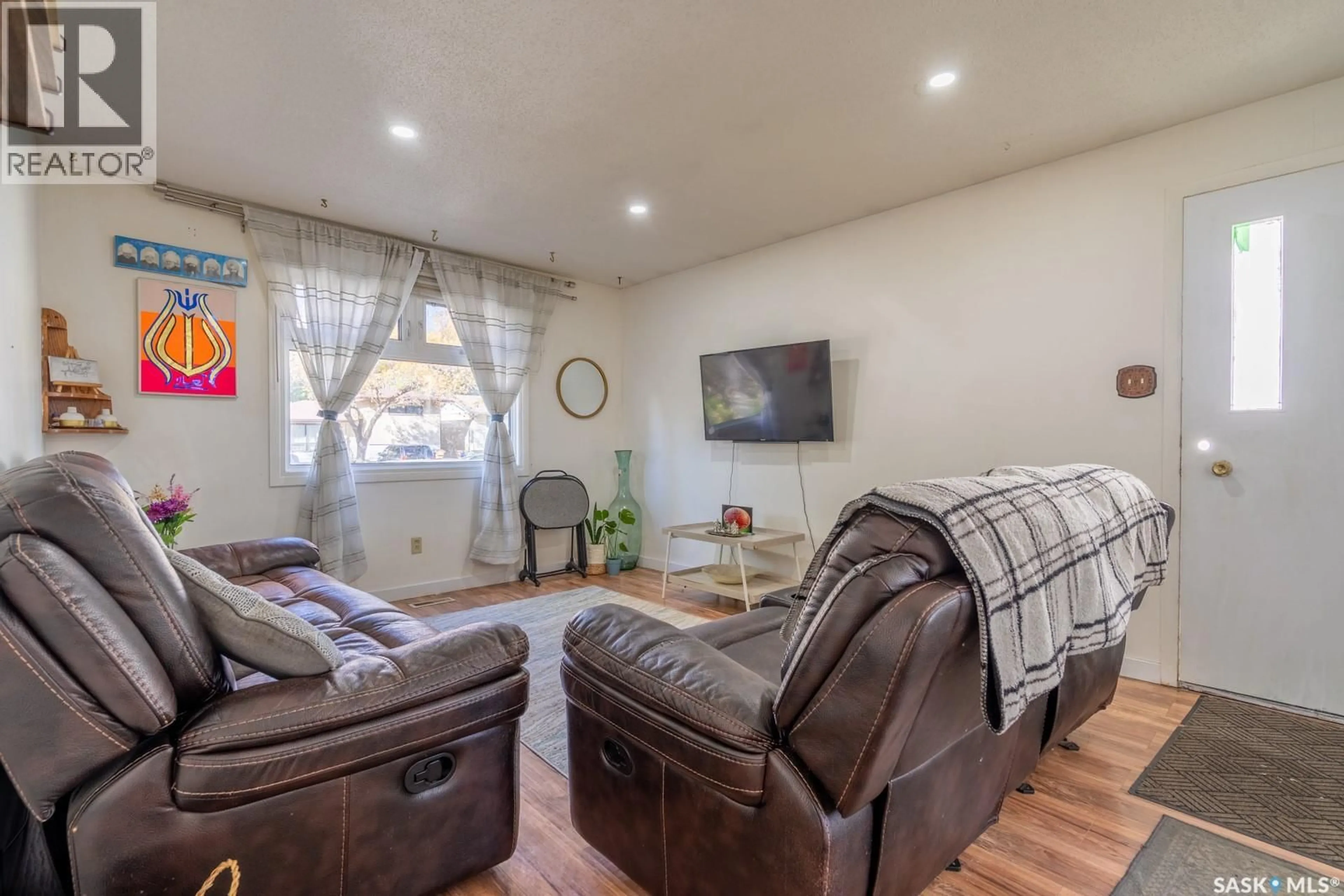 Living room with furniture, wood/laminate floor for 1357 GROSVENOR STREET, Regina Saskatchewan S4N1R2