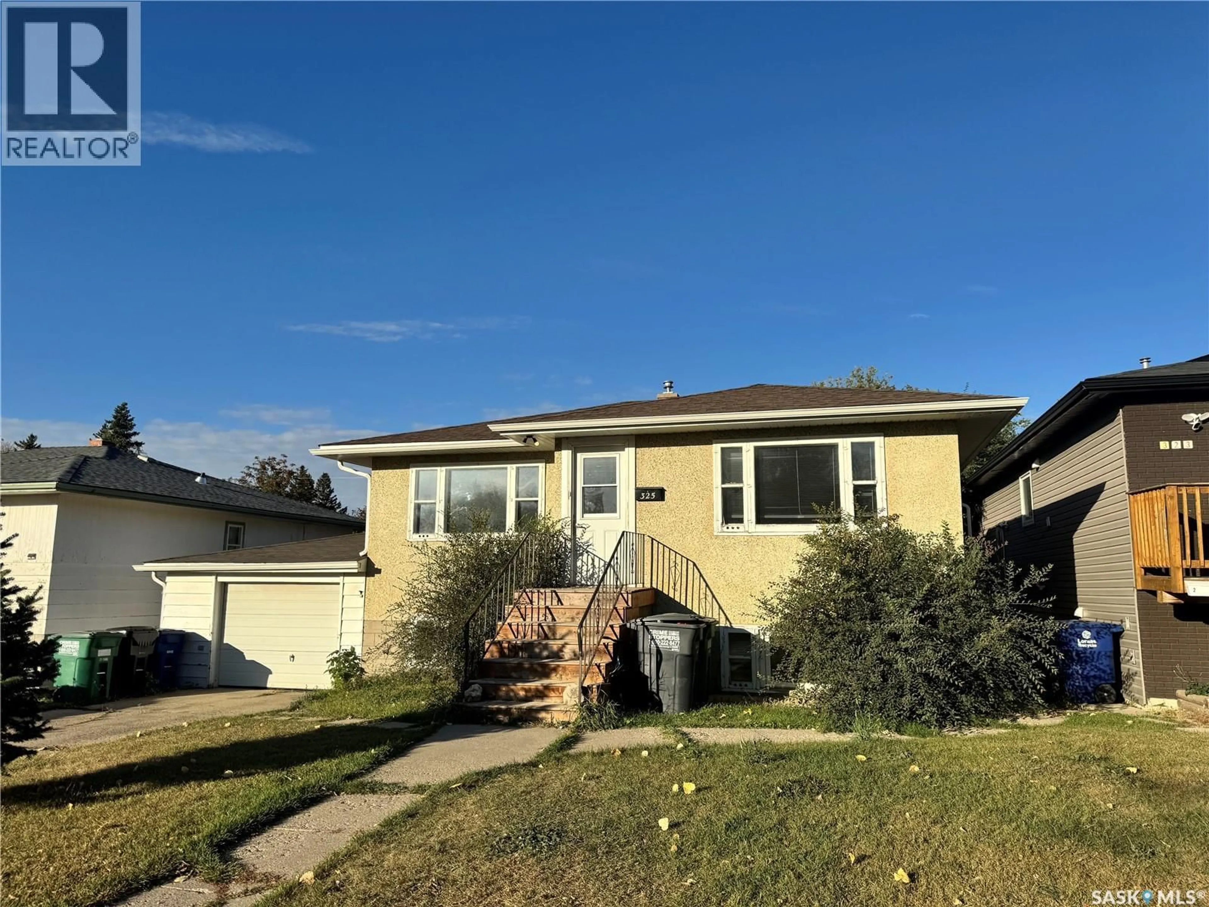 Home with vinyl exterior material, street for 325 V AVENUE, Saskatoon Saskatchewan S7M3E4