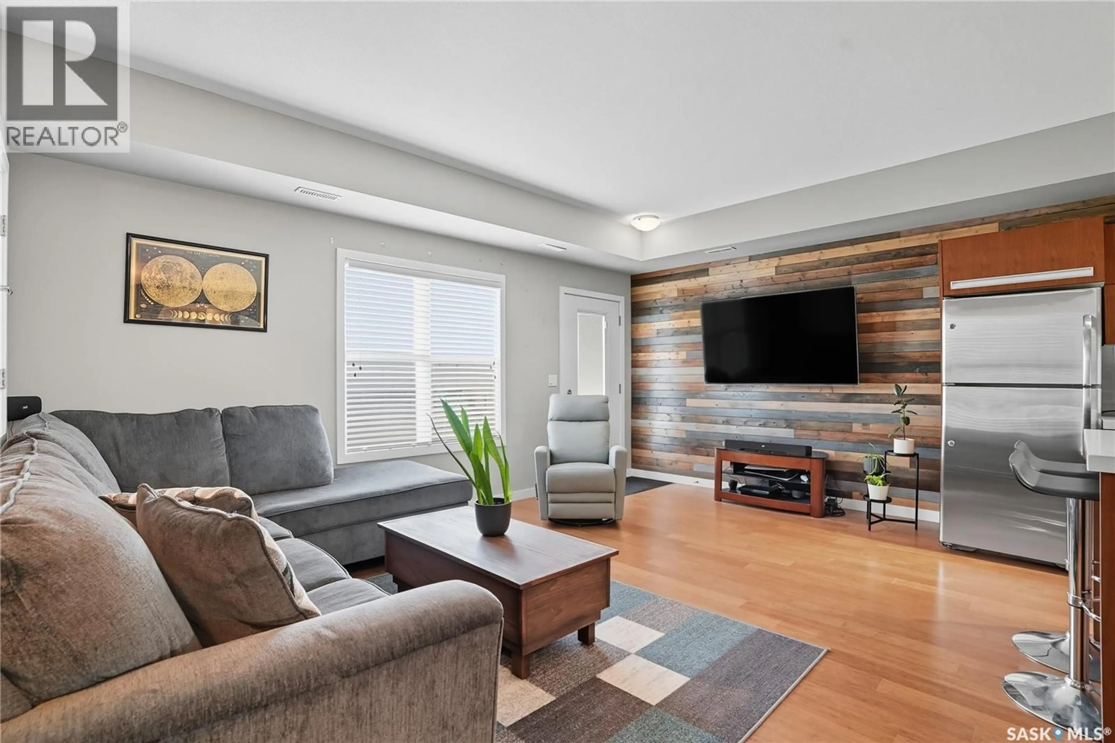 Living room with furniture, wood/laminate floor for 1015 - 408 PATRICK CRESCENT, Saskatoon Saskatchewan S7W0M3