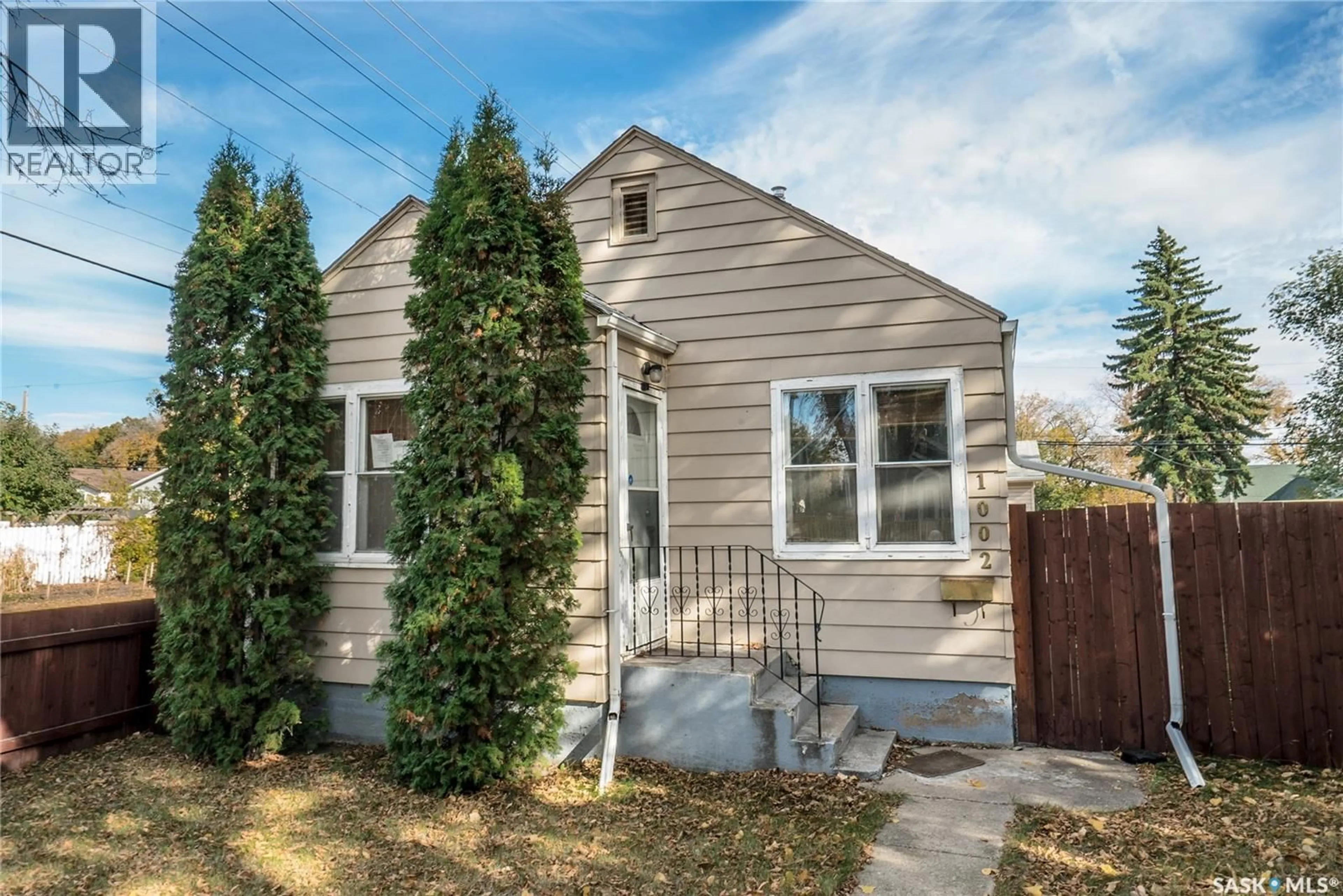 Home with vinyl exterior material, street for 1002 J AVENUE, Saskatoon Saskatchewan S7M2B9