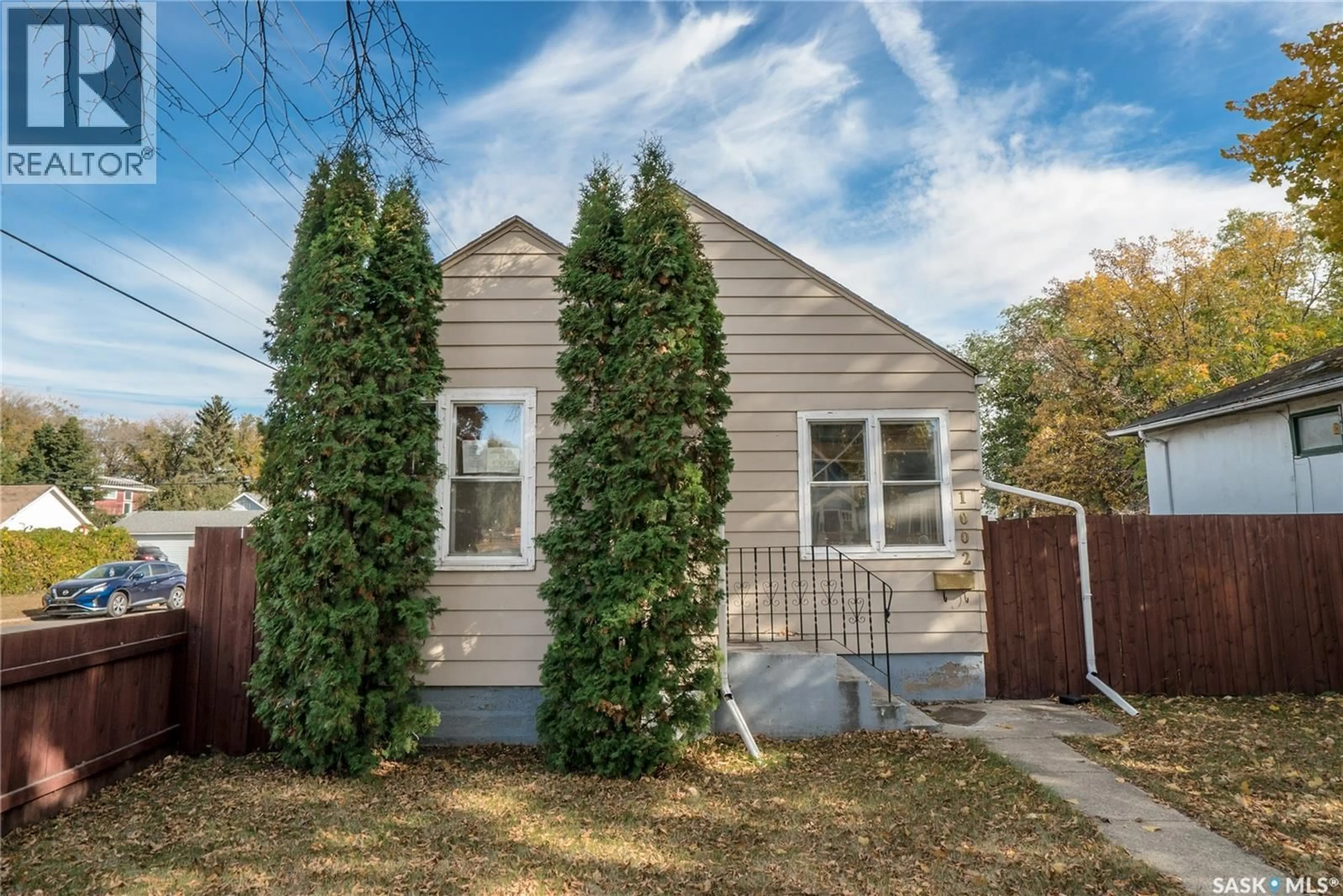 Home with vinyl exterior material, street for 1002 J AVENUE, Saskatoon Saskatchewan S7M2B9