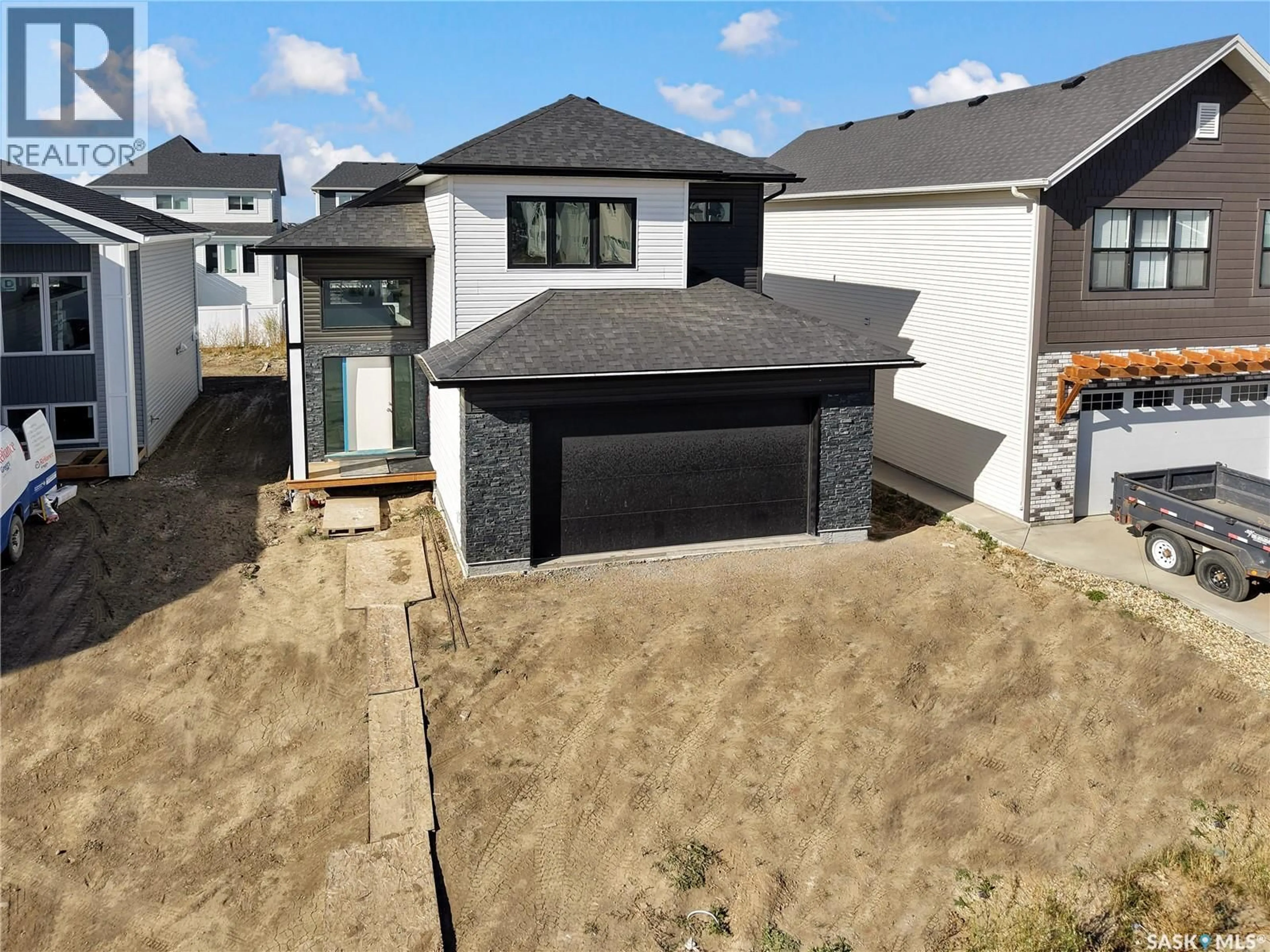 A pic from outside/outdoor area/front of a property/back of a property/a pic from drone, street for 114 HAVERSTOCK CRESCENT, Saskatoon Saskatchewan S7W1E2