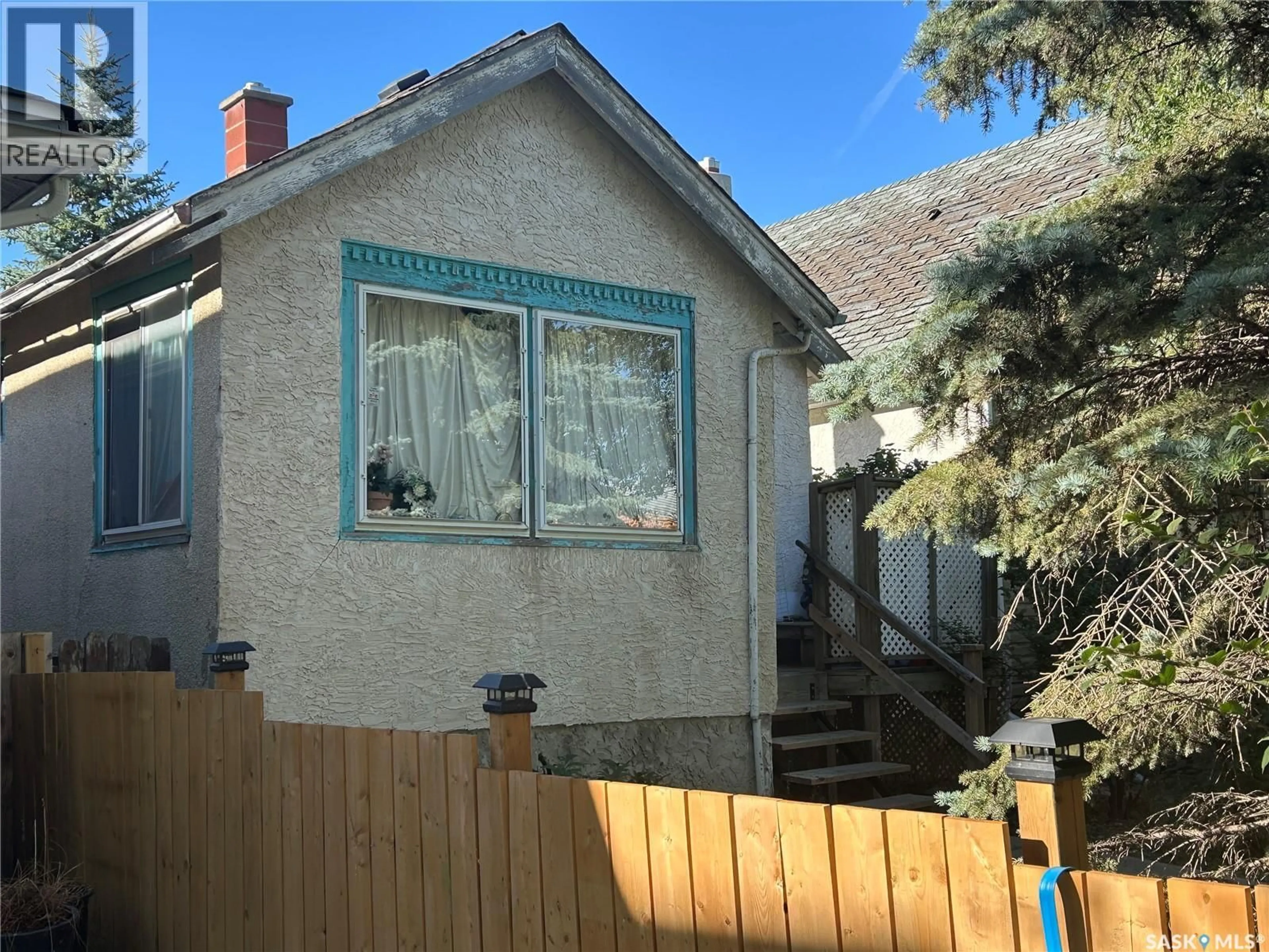 Home with vinyl exterior material, street for 2030 BRODER STREET, Regina Saskatchewan S4N3S2