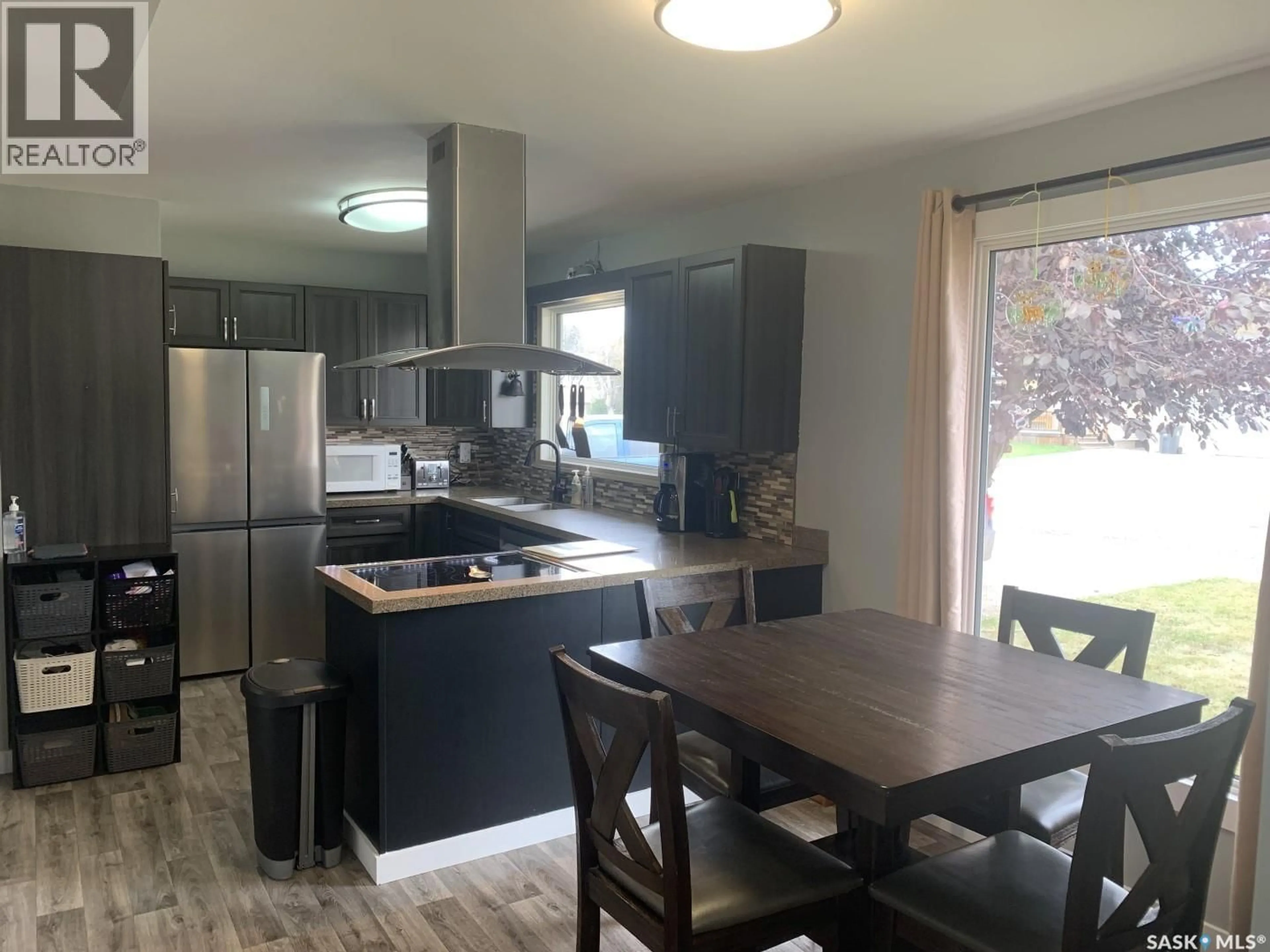 Open concept kitchen, wood/laminate floor for 410 3RD STREET, Langham Saskatchewan S0K2L0