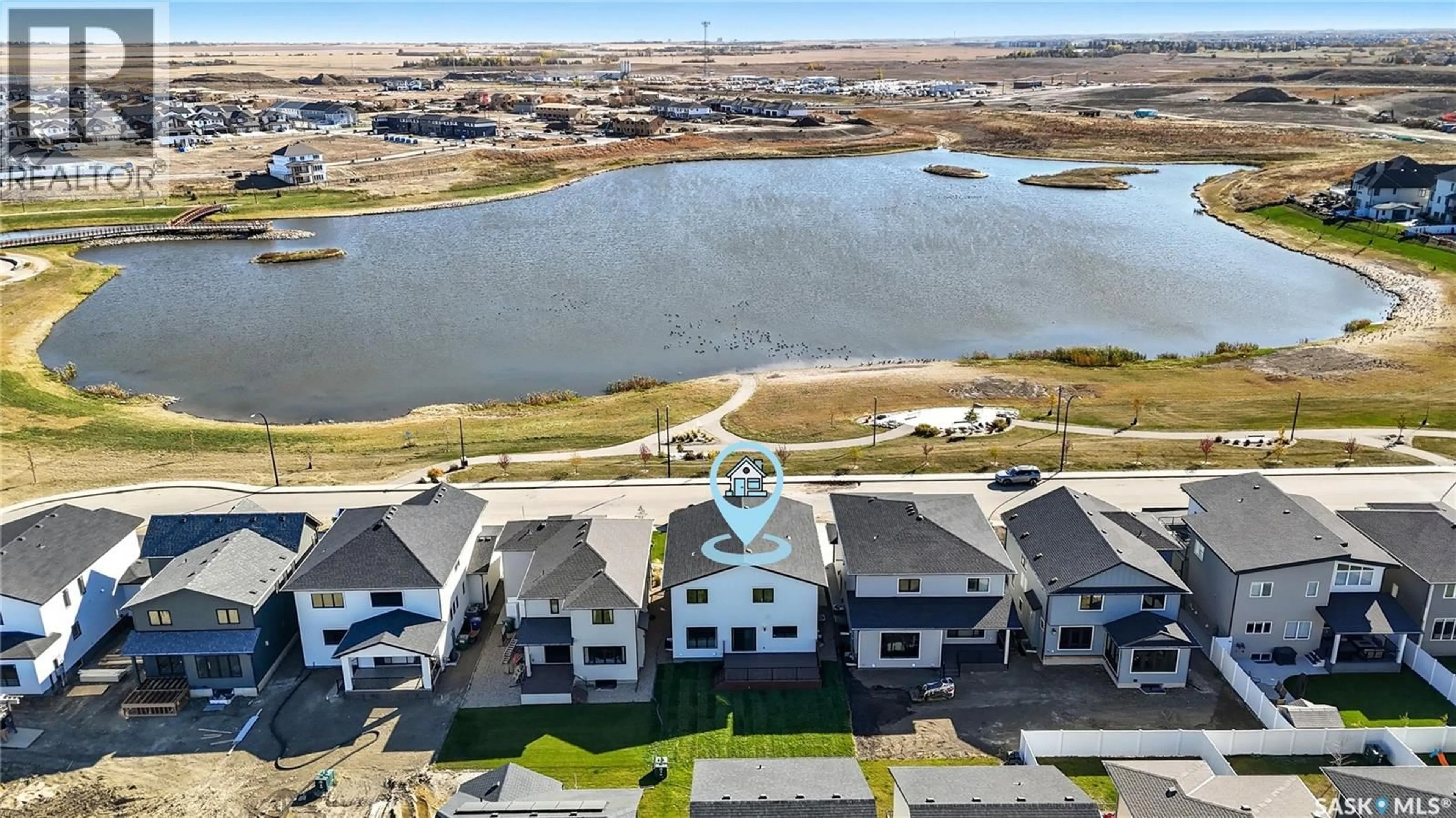 A pic from outside/outdoor area/front of a property/back of a property/a pic from drone, water/lake/river/ocean view for 318 TAUBE GREEN, Saskatoon Saskatchewan S7V1M4